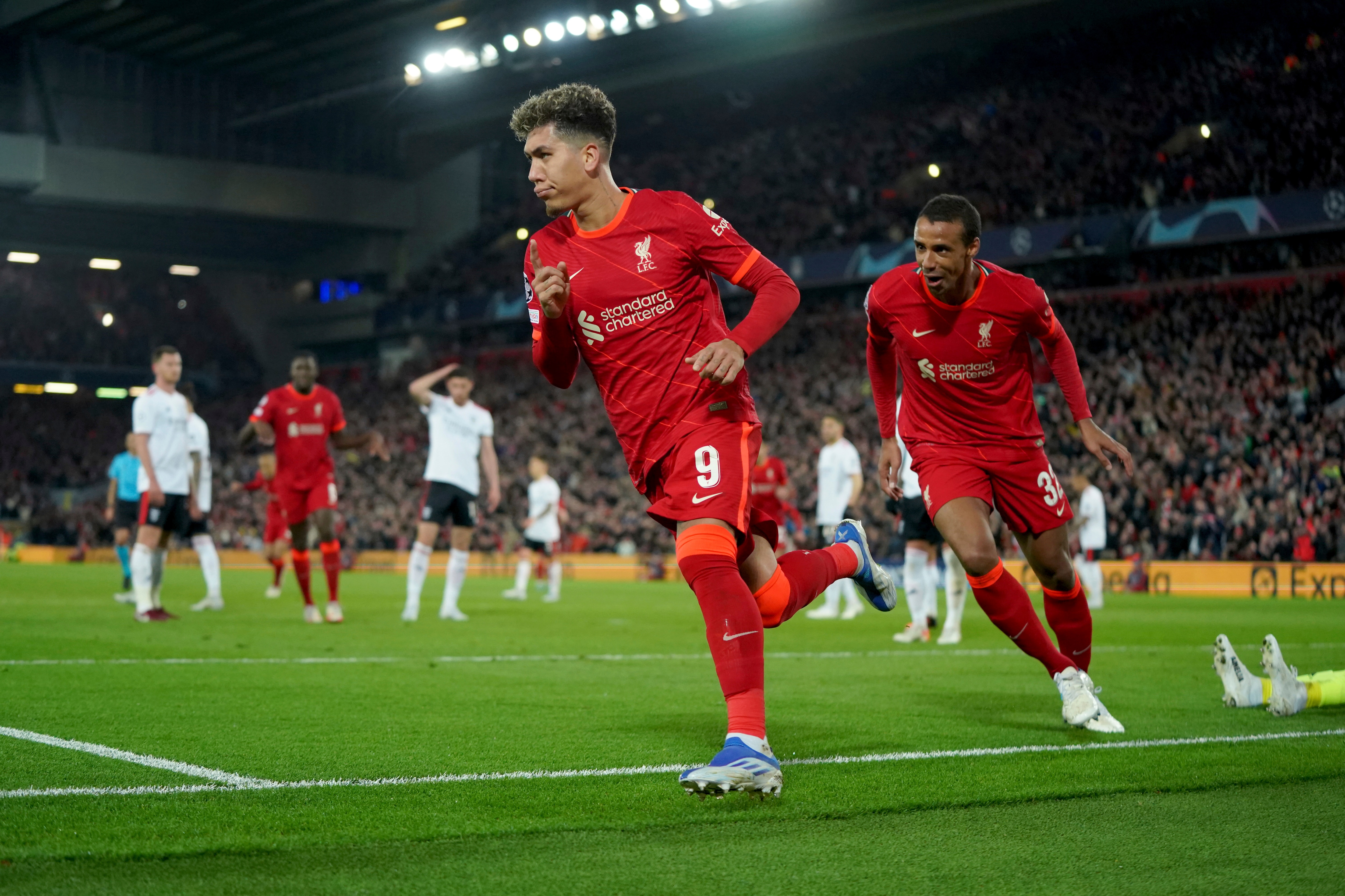 Liverpool's Roberto Firmino celebrates scoring his side's third goal during the Champions League quarterfinal second leg soccer match between Liverpool and Benfica, at Anfield stadium in Liverpool, England, Wednesday, April 13, 2022. (AP Photo/Jon Super)