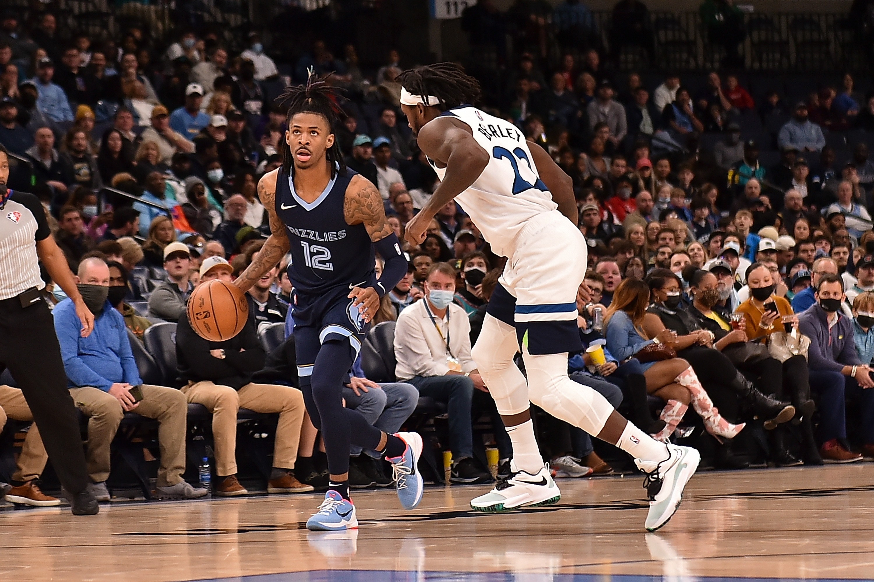 MEMPHIS, TENNESSEE - JANUARY 13: Ja Morant #12 of the Memphis Grizzlies handles the ball during the first half  against Patrick Beverley #22 of the Minnesota Timberwolve at FedExForum on January 13, 2022 in Memphis, Tennessee. NOTE TO USER: User expressly acknowledges and agrees that, by downloading and or using this photograph, User is consenting to the terms and conditions of the Getty Images License Agreement.  (Photo by Justin Ford/Getty Images)