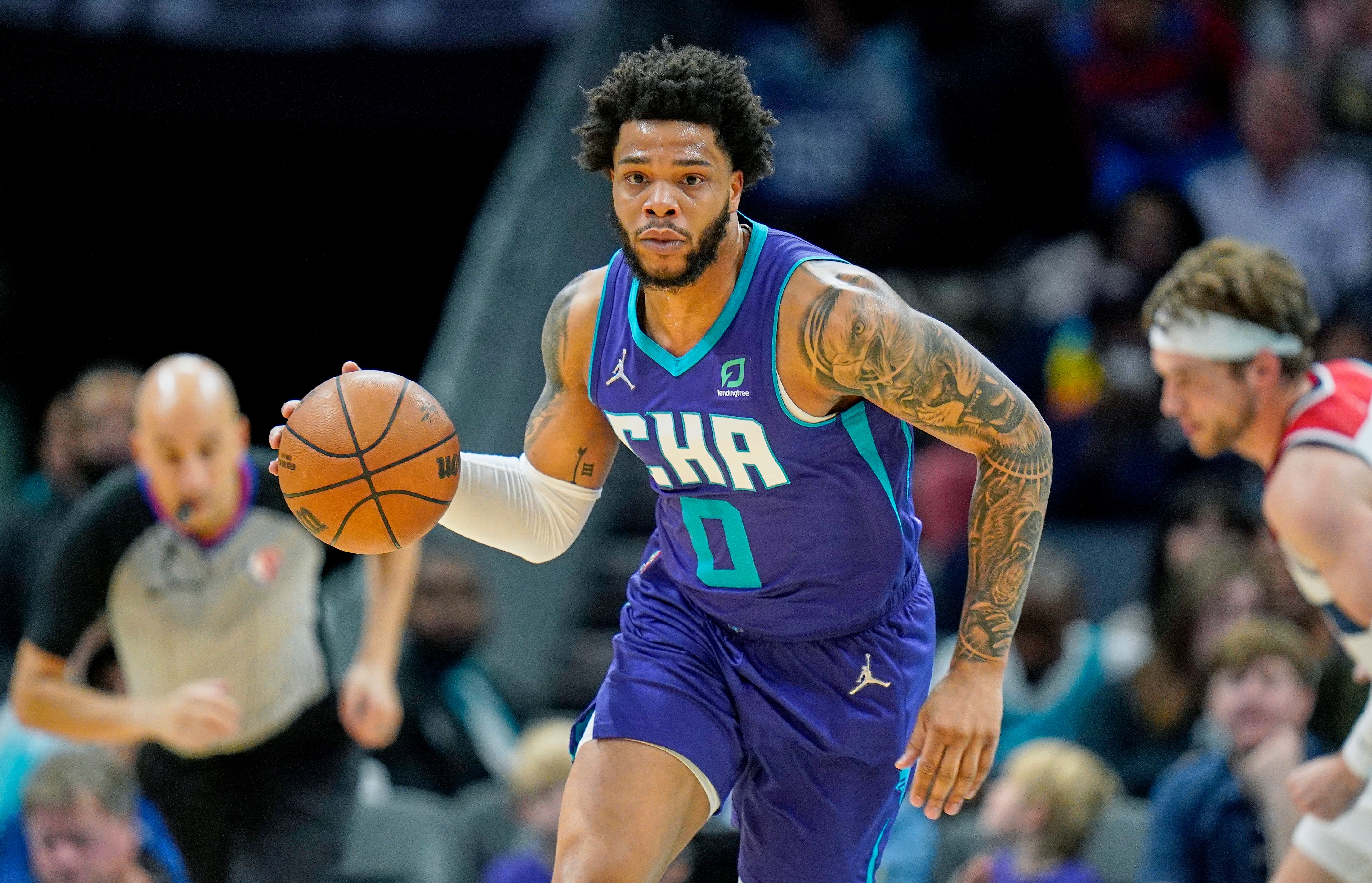 Charlotte Hornets forward Miles Bridges (0) brings the ball up court during an NBA basketball game against the Washington Wizards on Sunday, April 10, 2022, in Charlotte, N.C. (AP Photo/Rusty Jones)