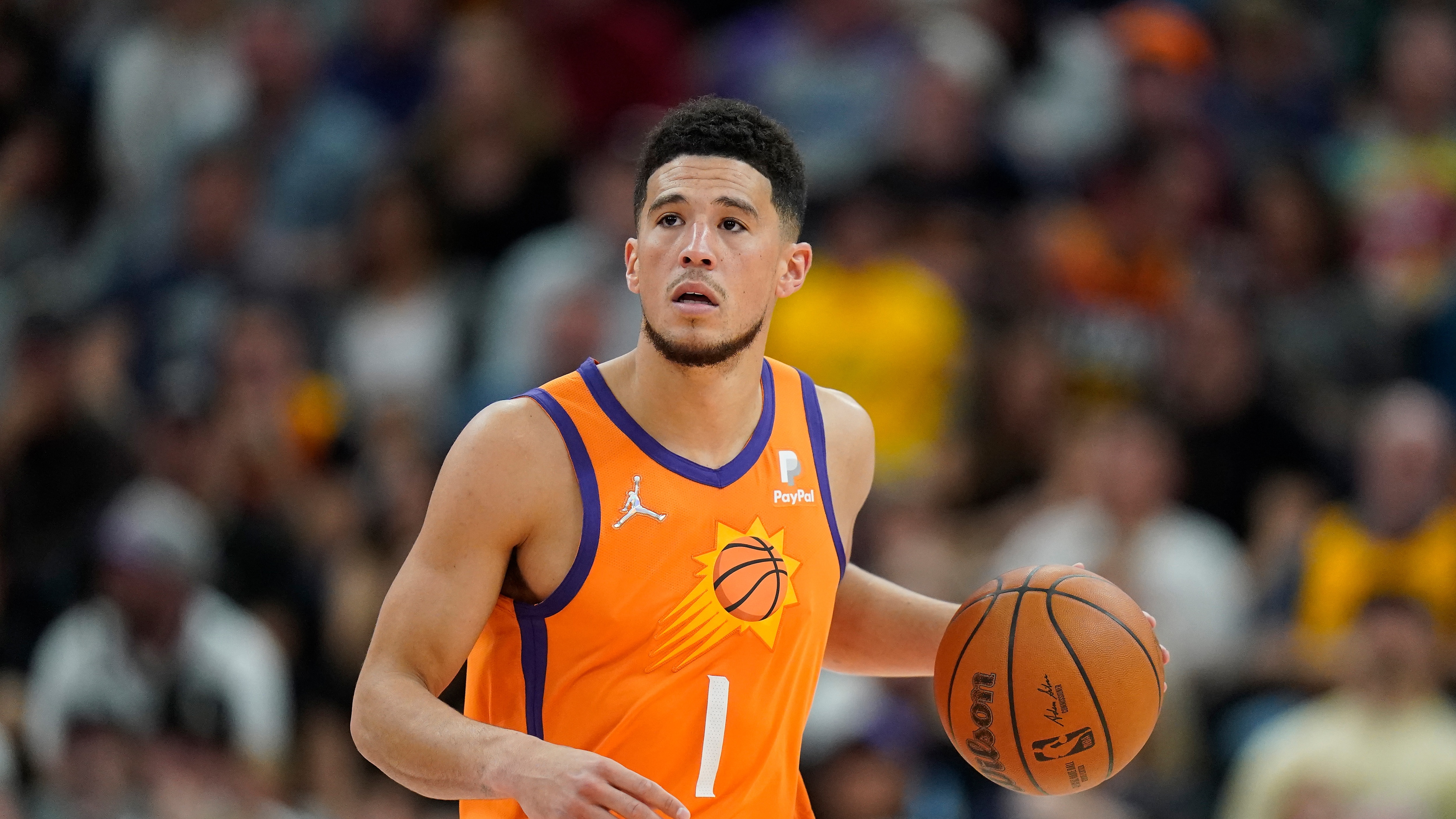 Phoenix Suns guard Devin Booker (1) brings the ball up court during the second half of an NBA basketball game against the Utah Jazz Friday, April 8, 2022, in Salt Lake City. (AP Photo/Rick Bowmer)