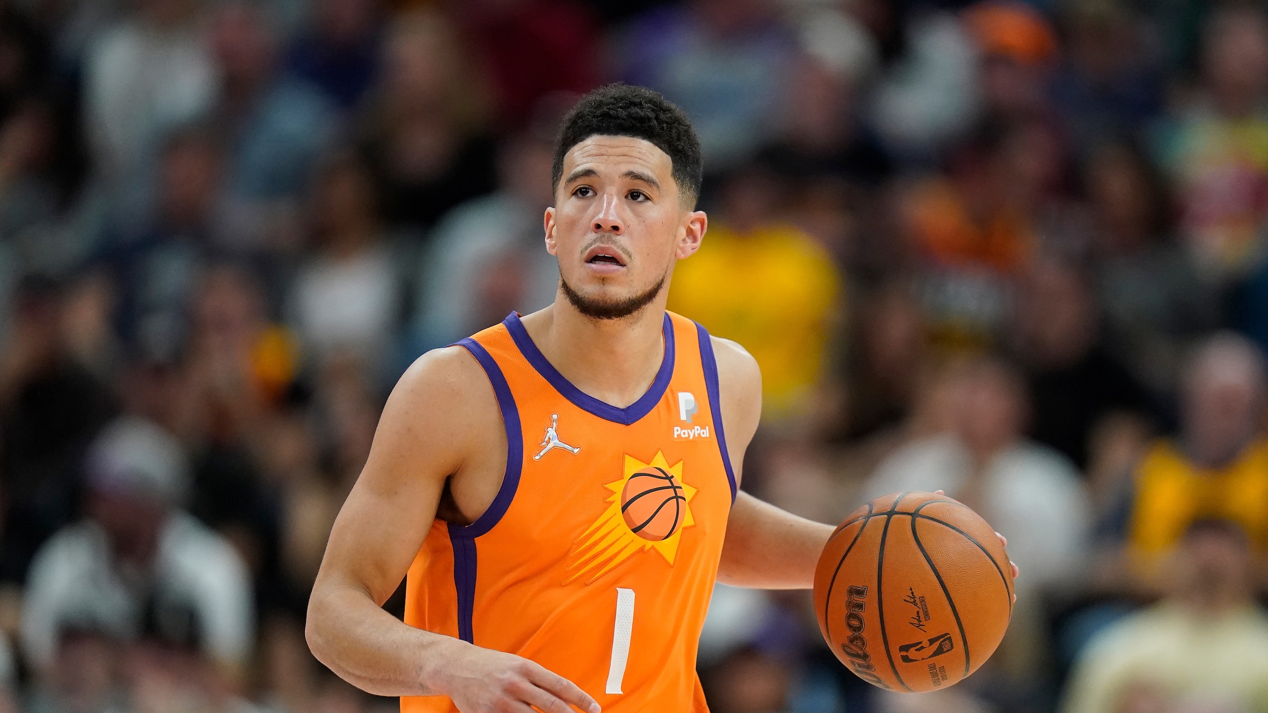 Phoenix Suns guard Devin Booker (1) brings the ball up court during the second half of an NBA basketball game against the Utah Jazz Friday, April 8, 2022, in Salt Lake City. (AP Photo/Rick Bowmer)