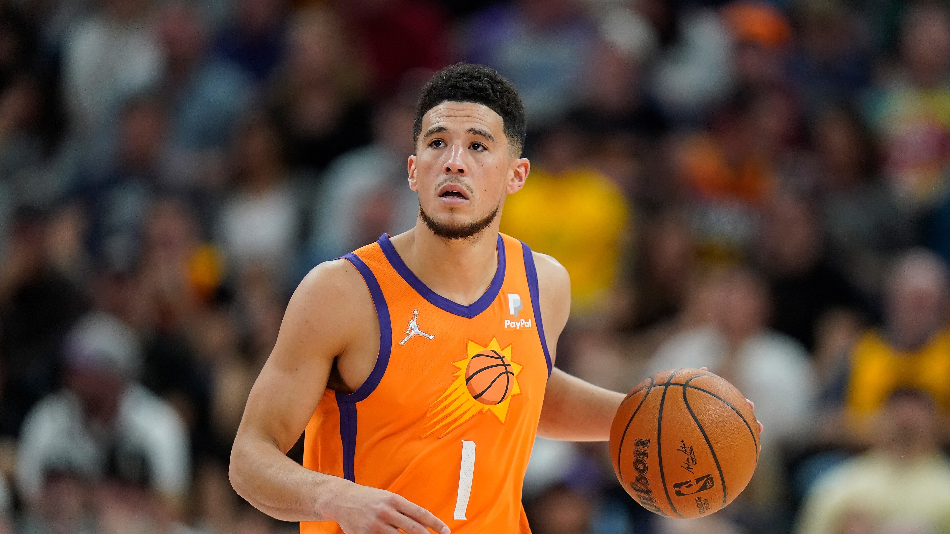 Phoenix Suns guard Devin Booker (1) brings the ball up court during the second half of an NBA basketball game against the Utah Jazz Friday, April 8, 2022, in Salt Lake City. (AP Photo/Rick Bowmer)