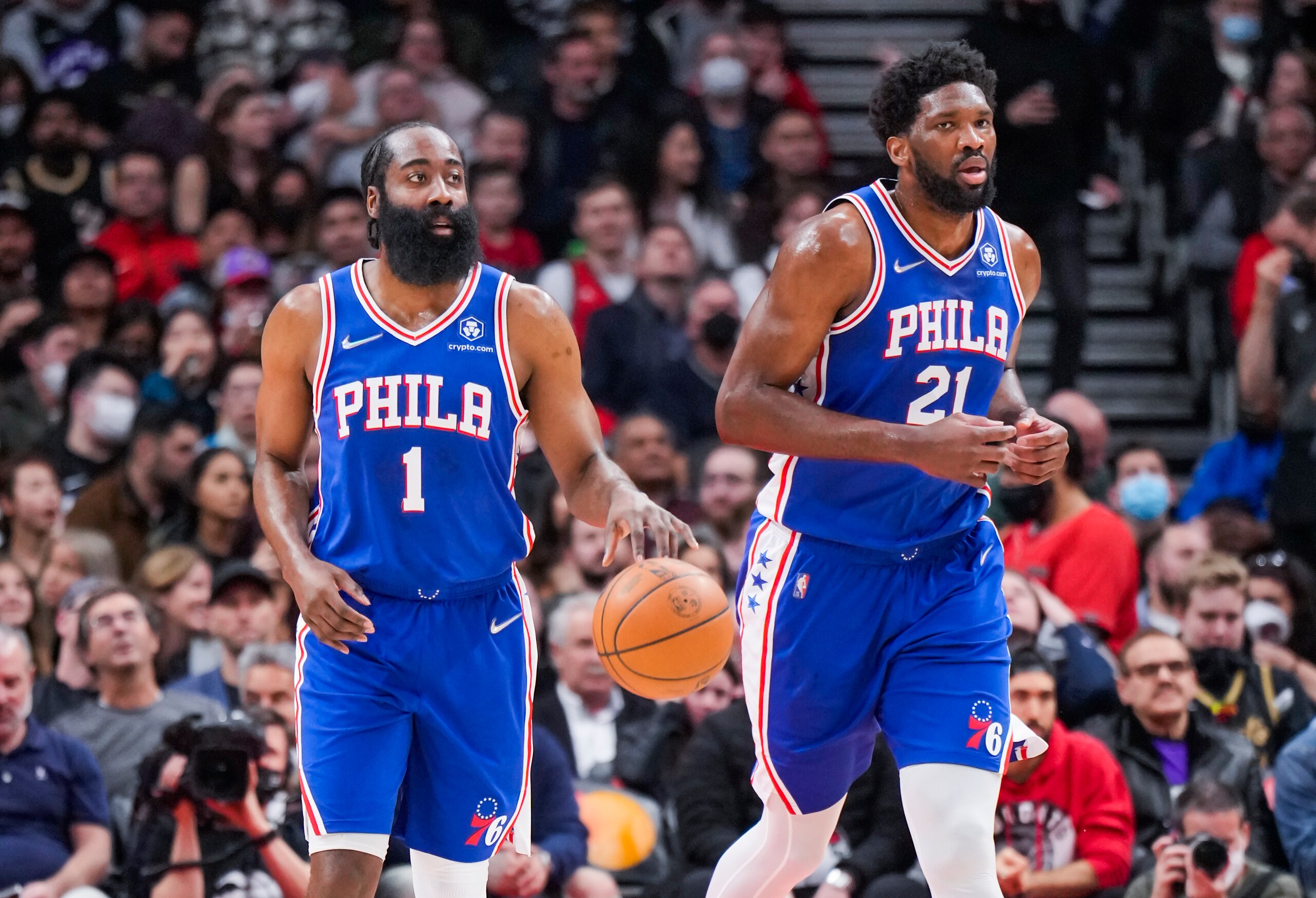 TORONTO, ON - APRIL 7: James Harden #1 of the Philadelphia 76ers brings the ball up the floor with Joel Embiid #21 against the Toronto Raptors during the first half of their basketball game at the Scotiabank Arena on April 7, 2022 in Toronto, Ontario, Canada. NOTE TO USER: User expressly acknowledges and agrees that, by downloading and/or using this Photograph, user is consenting to the terms and conditions of the Getty Images License Agreement. (Photo by Mark Blinch/Getty Images) TORONTO, ON - APRIL 7: James Harden #1 of the Philadelphia 76ers brings the ball up the floor with Joel Embiid #21 against the Toronto Raptors during the first half of their basketball game at the Scotiabank Arena on April 7, 2022 in Toronto, Ontario, Canada. NOTE TO USER: User expressly acknowledges and agrees that, by downloading and/or using this Photograph, user is consenting to the terms and conditions of the Getty Images License Agreement. (Photo by Mark Blinch/Getty Images)