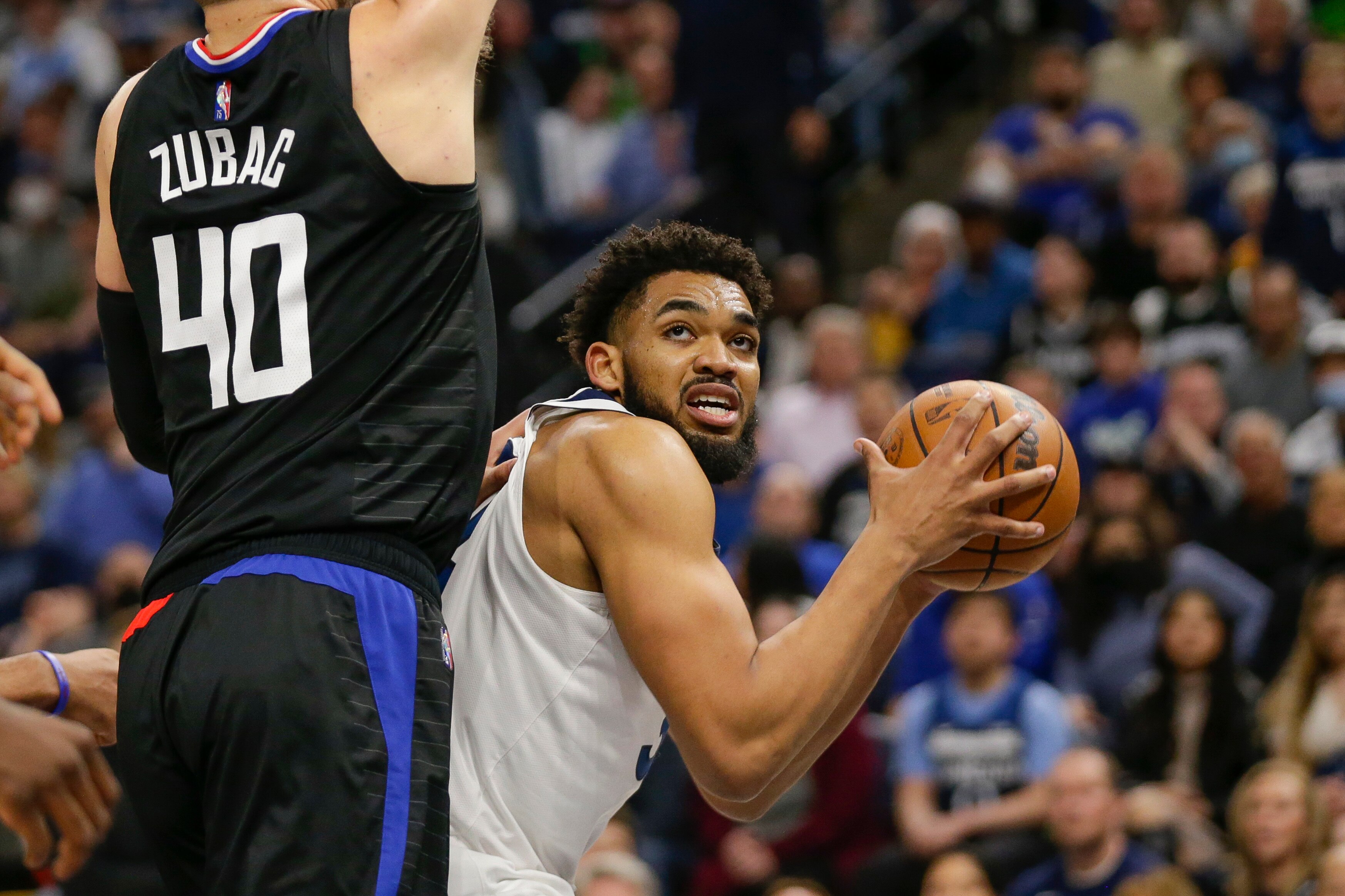 Minnesota Timberwolves center Karl-Anthony Towns (32) drives on Los Angeles Clippers center Ivica Zubac (40) during an NBA basketball game Tuesday, April 12, 2022, in Minneapolis. (AP Photo/Andy Clayton-King)
