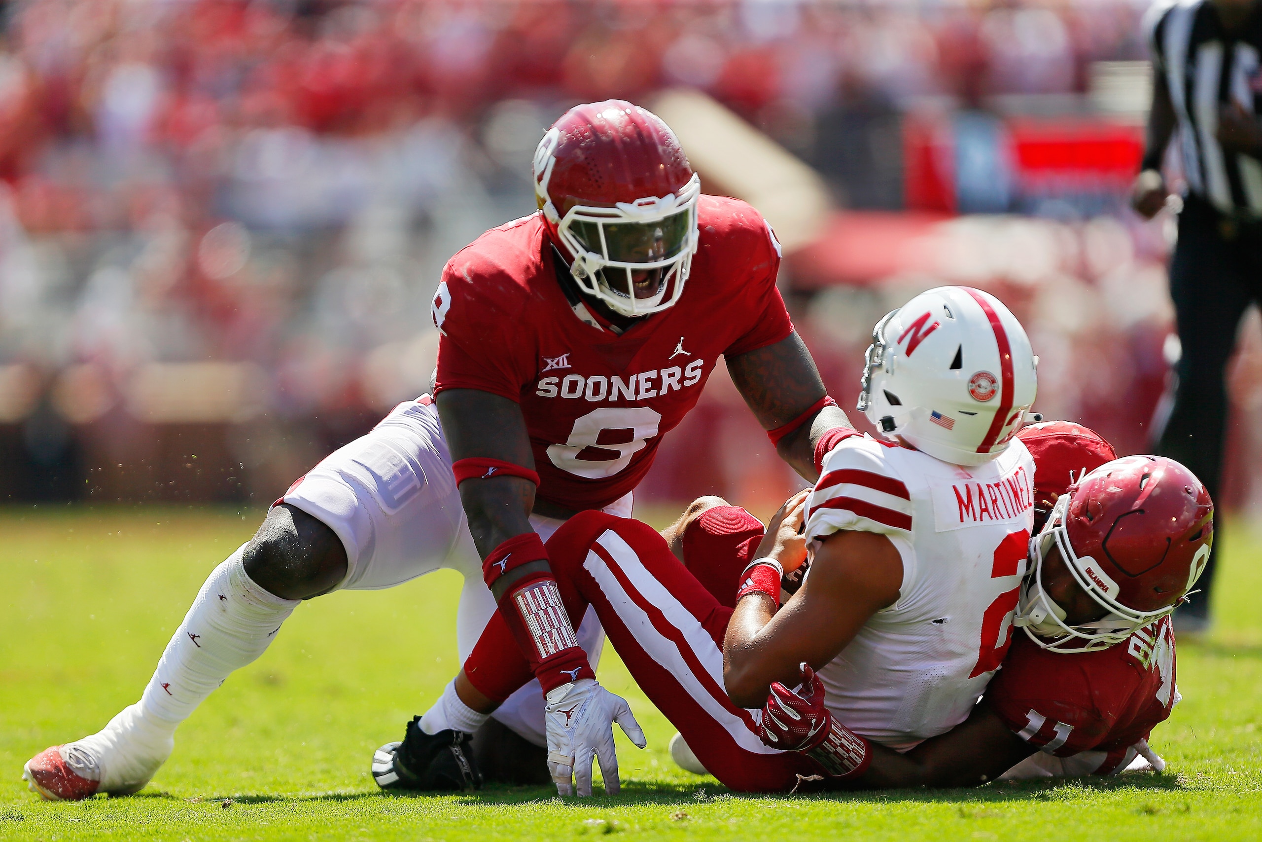 NORMAN, OK - SEPTEMBER 18: Defensive lineman Perrion Winfrey #8 and outside linebacker Nik Bonitto #11 of the Oklahoma Sooners sack quarterback Adrian Martinez #2 of the Nebraska Cornhuskers late on the last drive of the fourth quarter at Gaylord Family Oklahoma Memorial Stadium on September 18, 2021 in Norman, Oklahoma. Oklahoma won 23-16. (Photo by Brian Bahr/Getty Images) NORMAN, OK - SEPTEMBER 18: Defensive lineman Perrion Winfrey #8 and outside linebacker Nik Bonitto #11 of the Oklahoma Sooners sack quarterback Adrian Martinez #2 of the Nebraska Cornhuskers late on the last drive of the fourth quarter at Gaylord Family Oklahoma Memorial Stadium on September 18, 2021 in Norman, Oklahoma. Oklahoma won 23-16. (Photo by Brian Bahr/Getty Images)