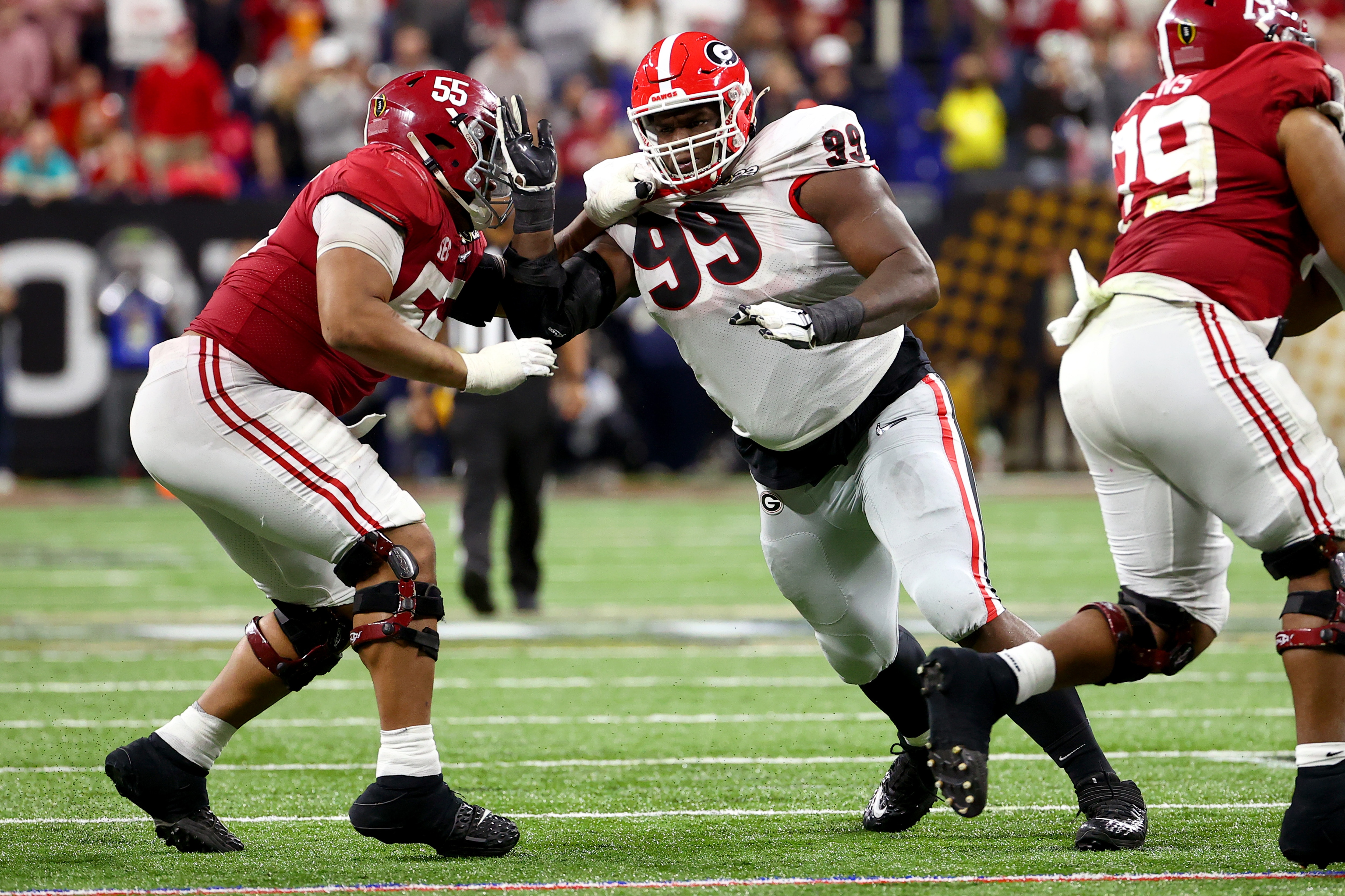 INDIANAPOLIS, IN - JANUARY 10: Jordan Davis #99 of the Georgia Bulldogs rushes the quarterback against Emil Ekiyor Jr. #55 of the Alabama Crimson Tide during the College Football Playoff Championship held at Lucas Oil Stadium on January 10, 2022 in Indianapolis, Indiana. (Photo by Jamie Schwaberow/Getty Images)