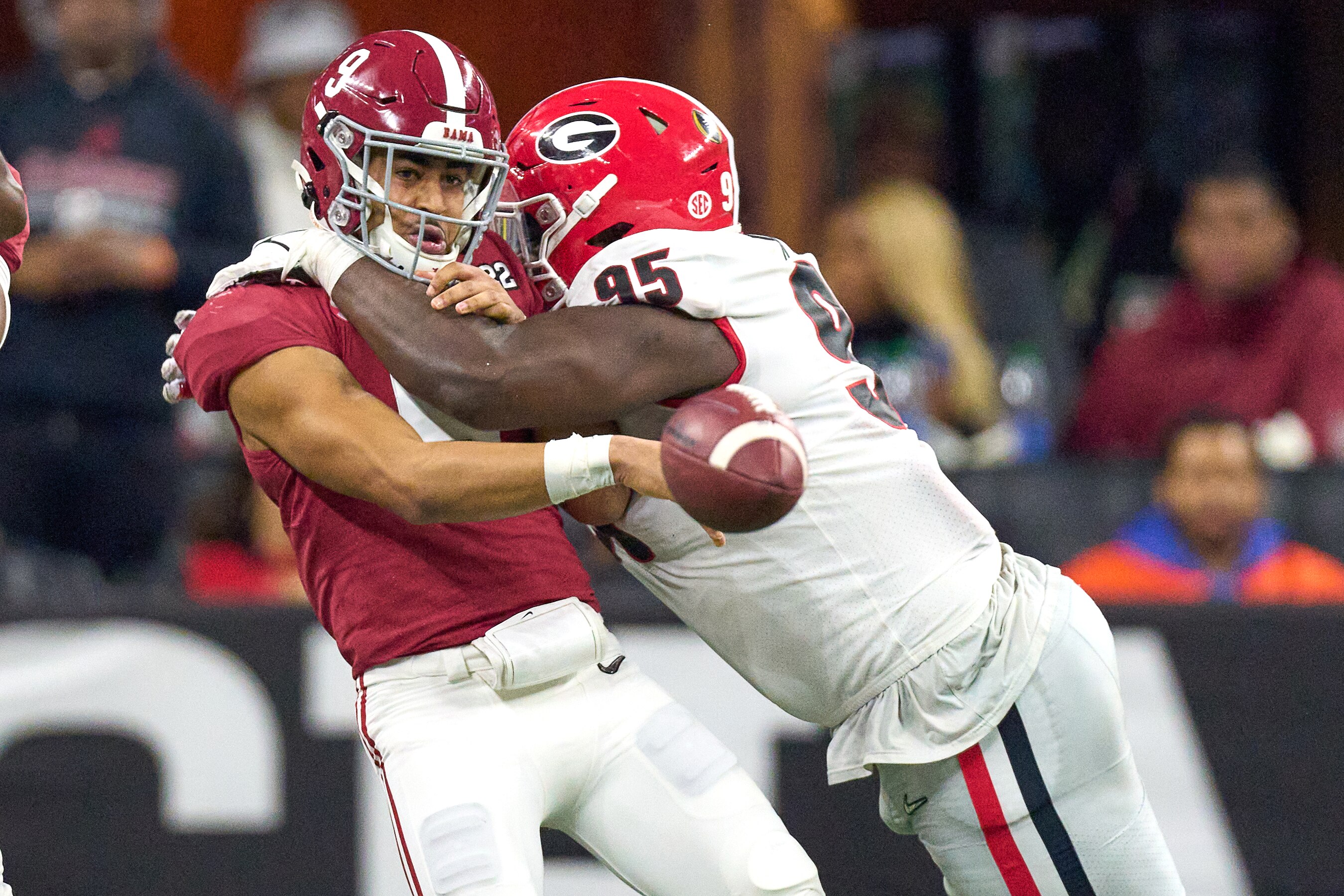 INDIANAPOLIS, IN - JANUARY 10: Alabama Crimson Tide quarterback Bryce Young (9) battles with Georgia Bulldogs defensive lineman Devonte Wyatt (95) during the Alabama Crimson Tide versus the Georgia Bulldogs in the College Football Playoff National Championship, on January 10, 2022, at Lucas Oil Stadium in Indianapolis, IN. (Photo by Robin Alam/Icon Sportswire via Getty Images)