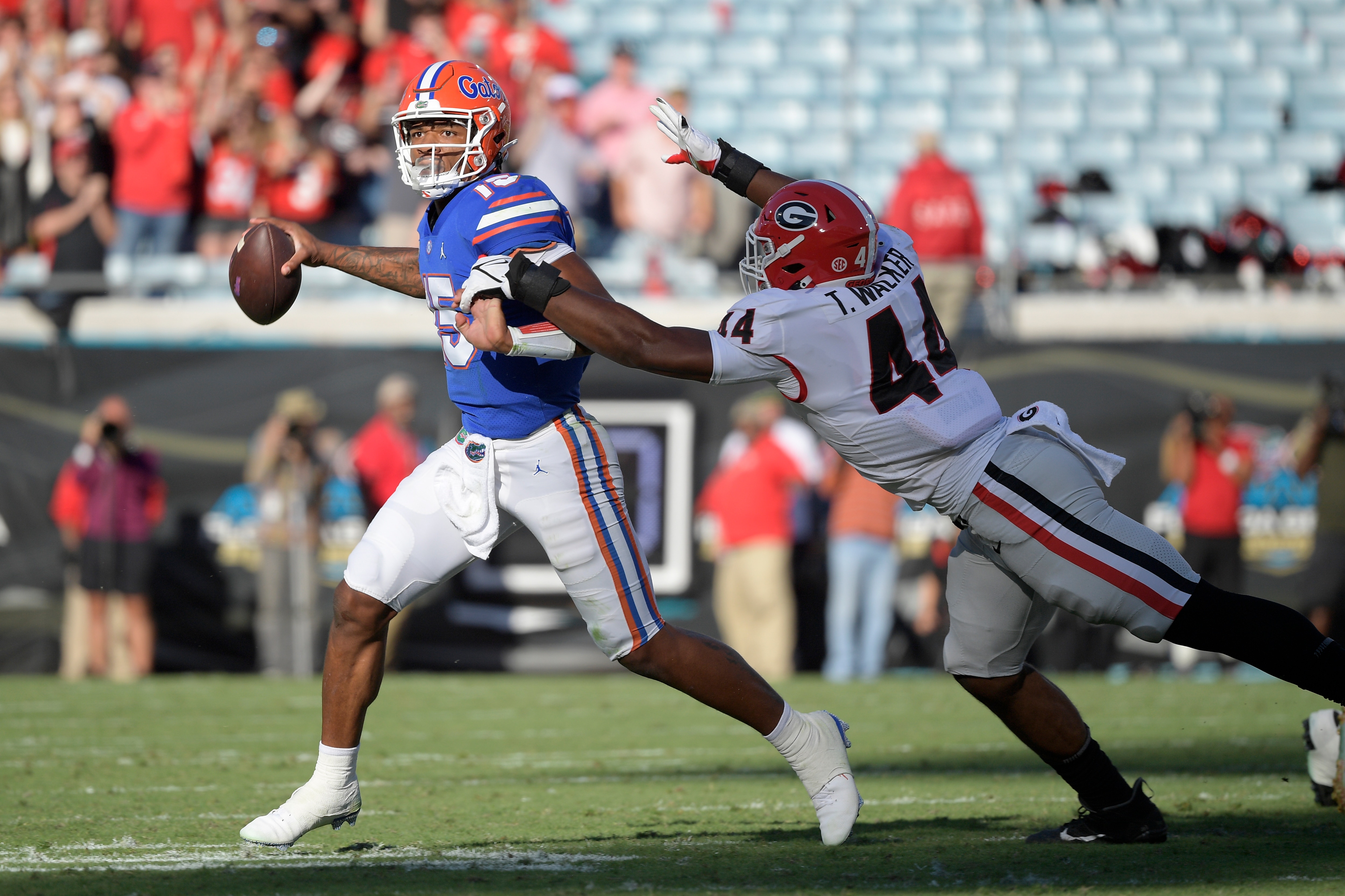 Florida quarterback Anthony Richardson (15) throws a pass while under pressure from Georgia defensive lineman Travon Walker (44) during the first half of an NCAA college football game, Saturday, Oct. 30, 2021, in Jacksonville, Fla. (AP Photo/Phelan M. Ebenhack)