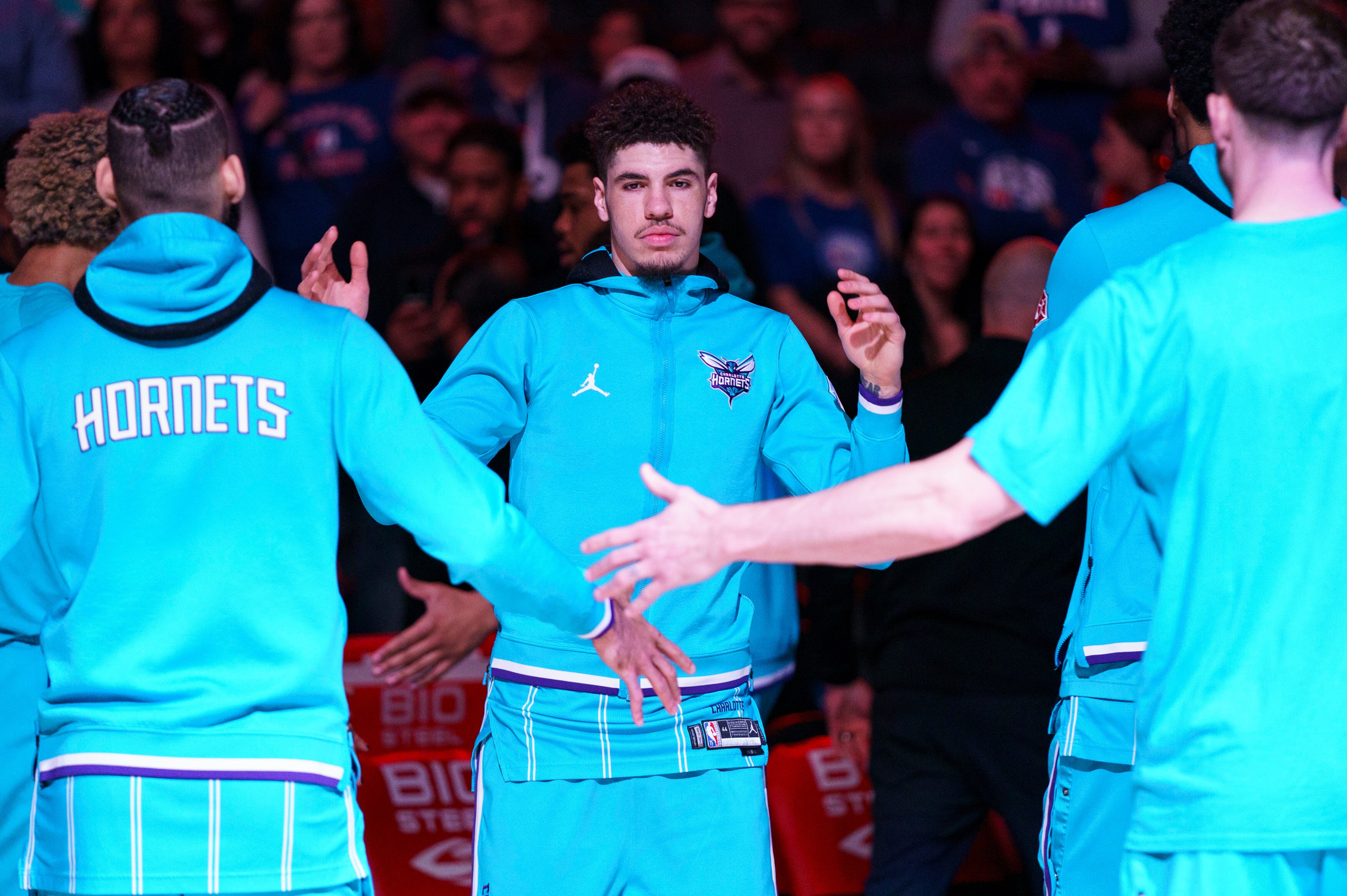 Charlotte Hornets' LaMelo Ball, center, comes out for player introductions during an NBA basketball game against the Philadelphia 76ers, Saturday, April 2, 2022, in Philadelphia. (AP Photo/Chris Szagola)