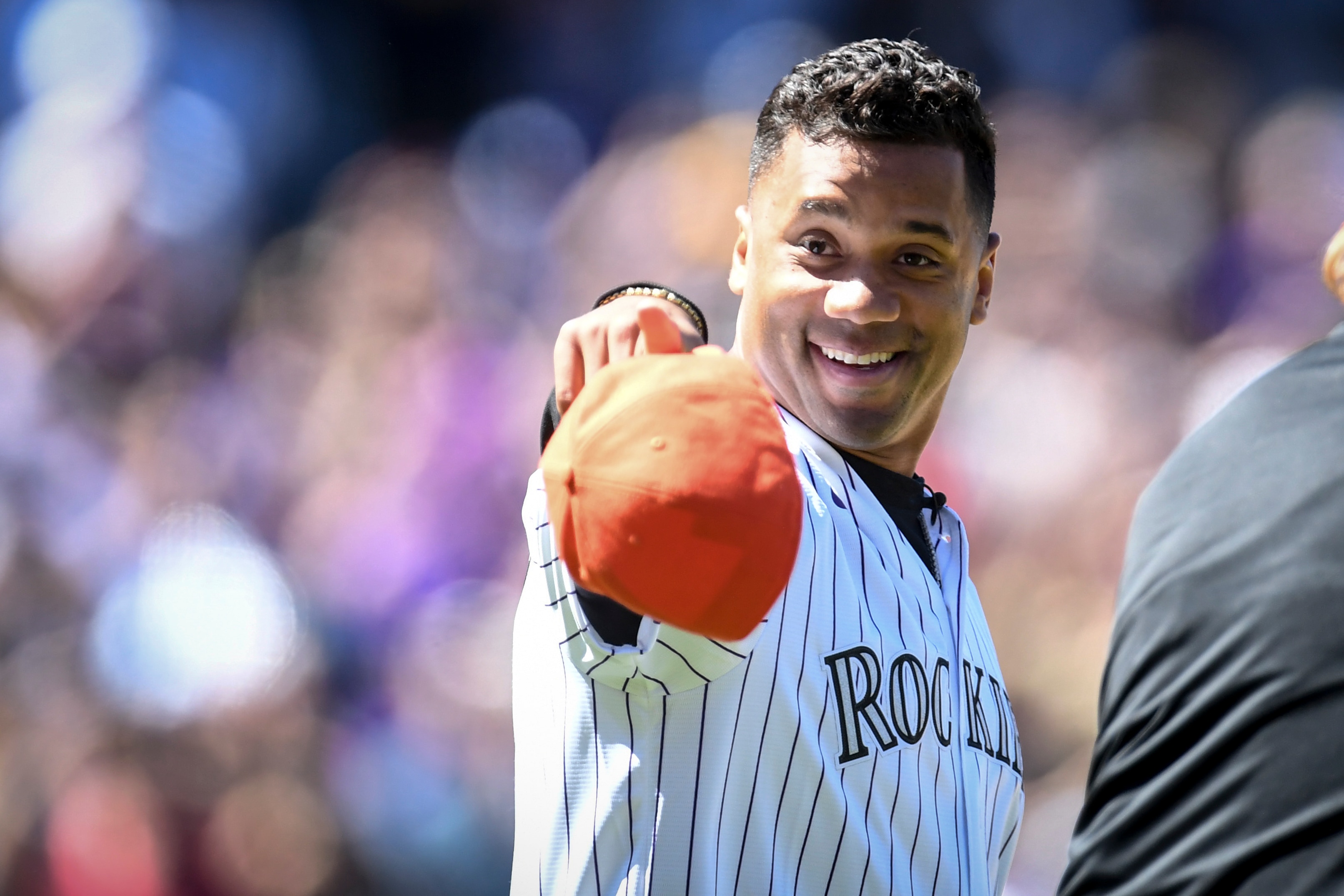 DENVER, CO - APRIL 8: Denver Broncos quarterback Russell Wilson shouts to the crowd ahead of throwing the first pitch before the first inning of Opening Day between the Colorado Rockies and the Los Angeles Dodgers at Coors Field on Friday, April 8, 2022. (Photo by AAron Ontiveroz/MediaNews Group/The Denver Post via Getty Images)
