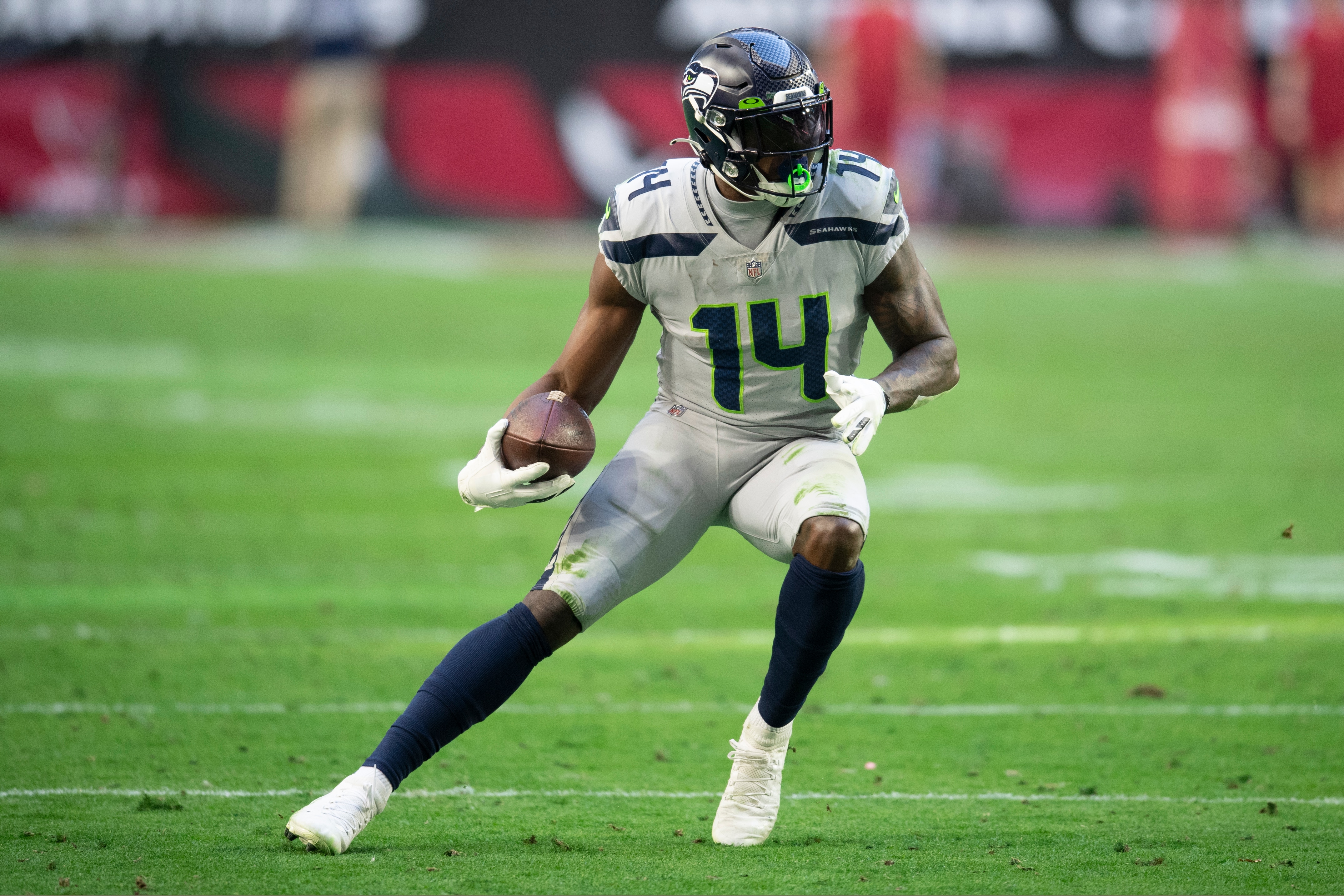 Seattle Seahawks wide receiver DK Metcalf (14) runs the ball against the Arizona Cardinals during an NFL Professional Football Game Sunday, Jan. 9, 2022, in Phoenix. (AP Photo/John McCoy)