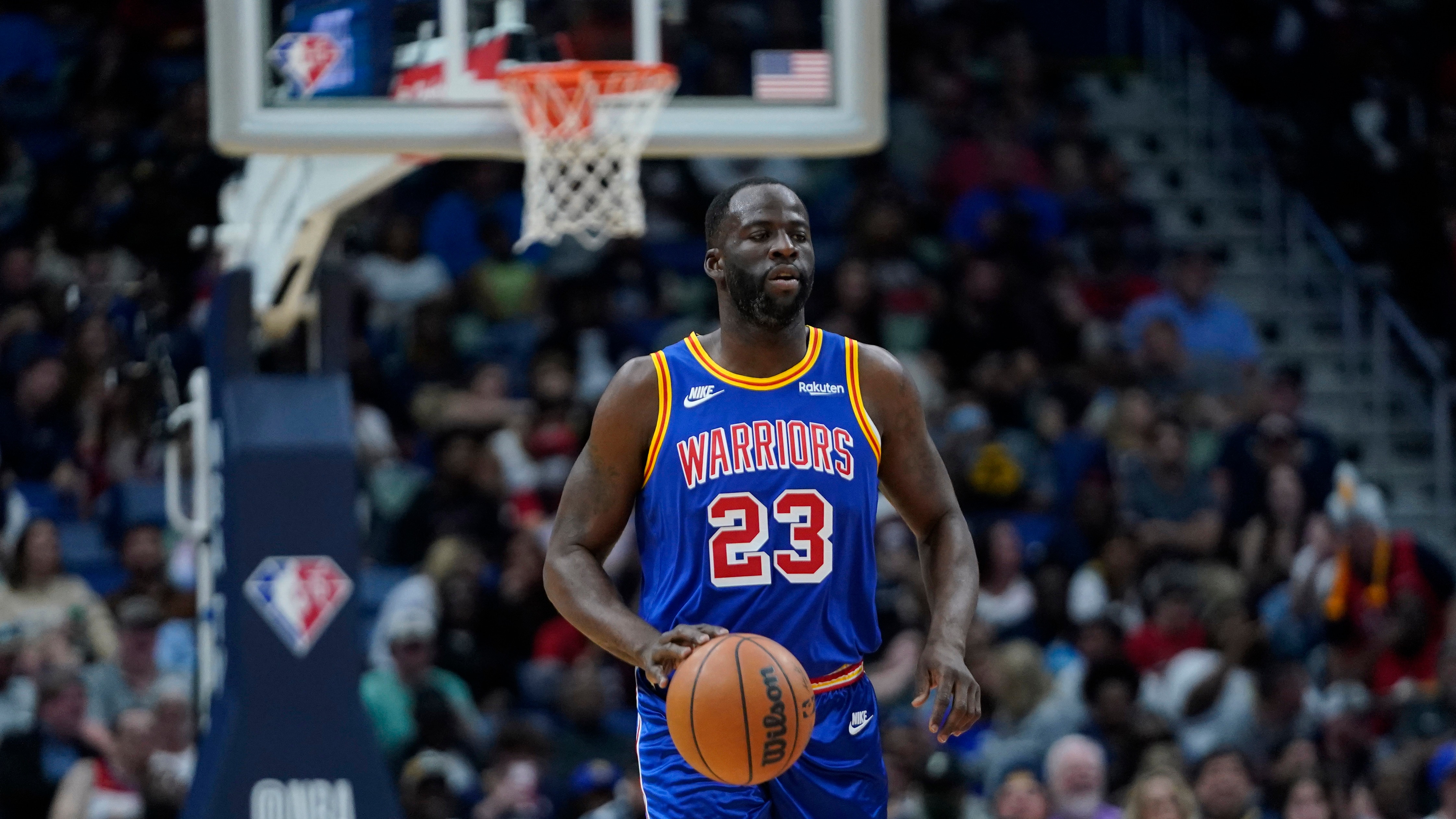 Golden State Warriors forward Draymond Green (23) moves the ball down court in the first half of an NBA basketball game against the New Orleans Pelicans in New Orleans, Sunday, April 10, 2022. (AP Photo/Gerald Herbert)