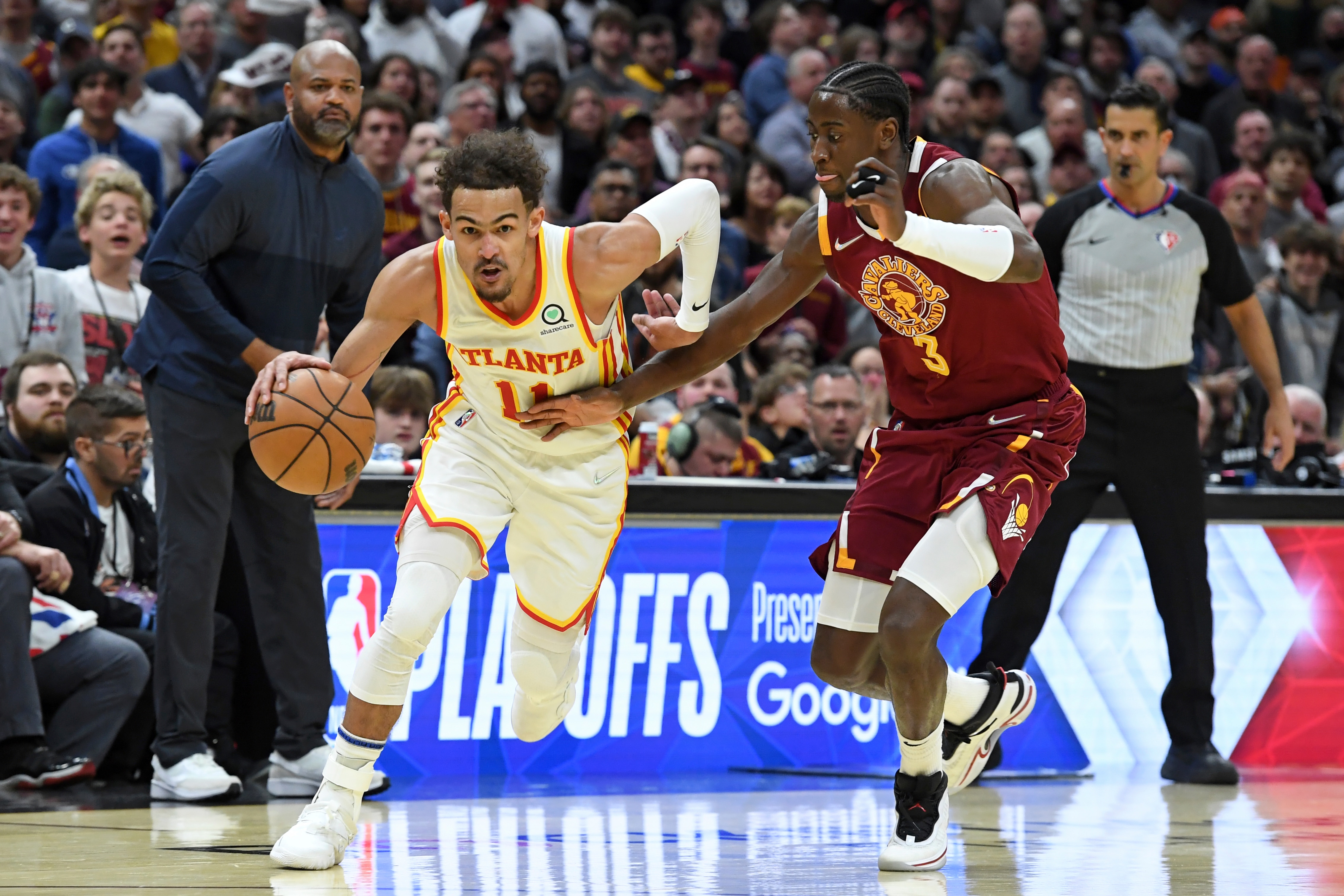 Atlanta Hawks' Trae Young (11) drives against Cleveland Cavaliers' Caris LeVert (3) in the second half of an NBA play-in basketball game Friday, April 15, 2022, in Cleveland. (AP Photo/Nick Cammett)