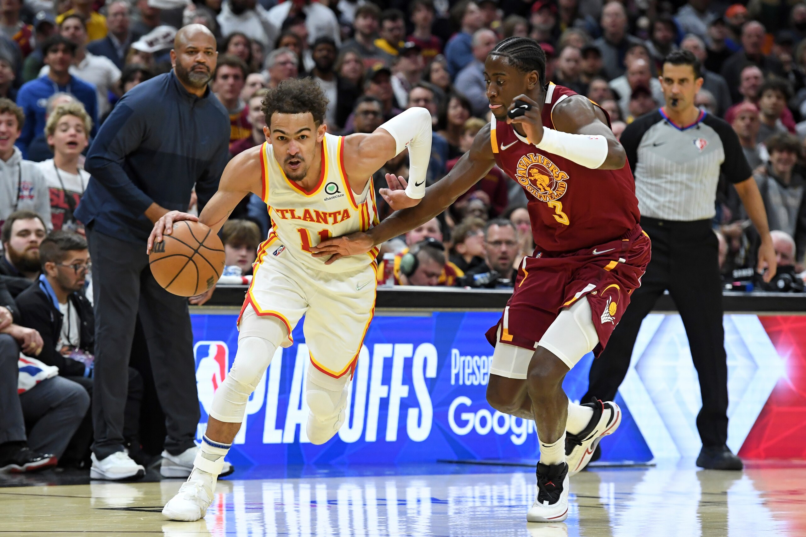 Atlanta Hawks' Trae Young (11) drives against Cleveland Cavaliers' Caris LeVert (3) in the second half of an NBA play-in basketball game Friday, April 15, 2022, in Cleveland. (AP Photo/Nick Cammett)