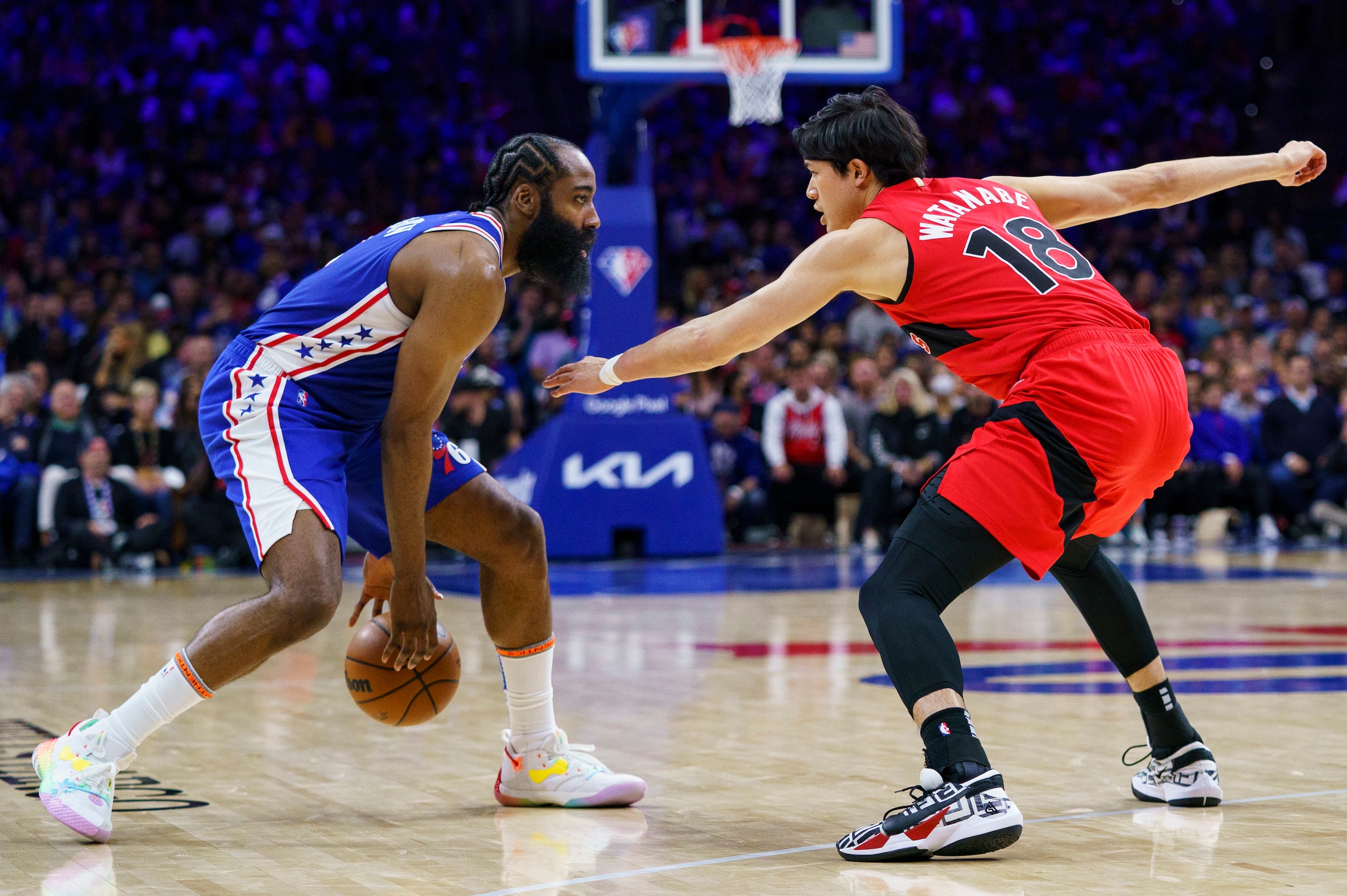 Philadelphia 76ers' James Harden, left, in action against Toronto Raptors' Yuta Watanabe, right, during Game 1 of an NBA basketball first-round playoff series, Saturday, April 16, 2022, in Philadelphia. The 76ers won 131-111. (AP Photo/Chris Szagola)
