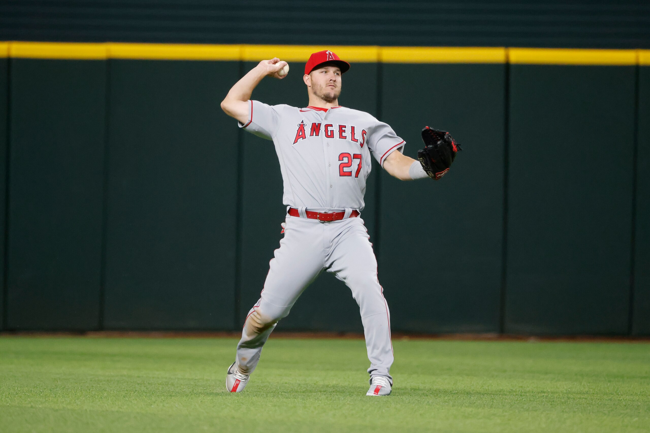 Los Angeles Angels center fielder Mike Trout (27) throws the ball after a hit by the Texas Rangers during the fifth inning of a baseball game, Thursday, April 14, 2022, in Arlington, Texas. (AP Photo/Michael Ainsworth)