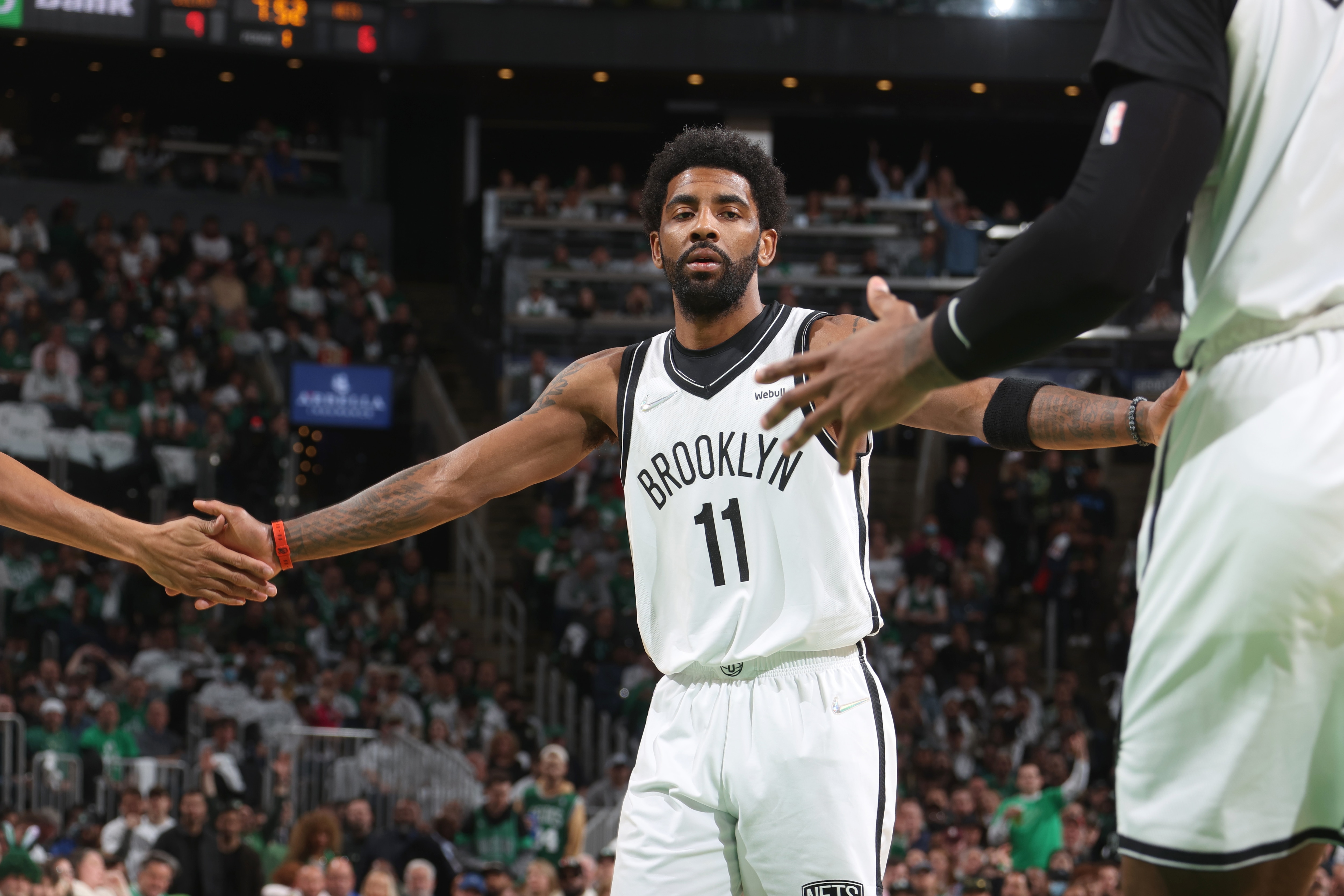 BOSTON, MA - APRIL 17: Kyrie Irving #11 of the Brooklyn Nets high fives his teammates during Round 1 Game 1 of the 2022 NBA Playoffs on April 17, 2022 at the TD Garden in Boston, Massachusetts.  NOTE TO USER: User expressly acknowledges and agrees that, by downloading and or using this photograph, User is consenting to the terms and conditions of the Getty Images License Agreement. Mandatory Copyright Notice: Copyright 2022 NBAE  (Photo by Nathaniel S. Butler/NBAE via Getty Images)