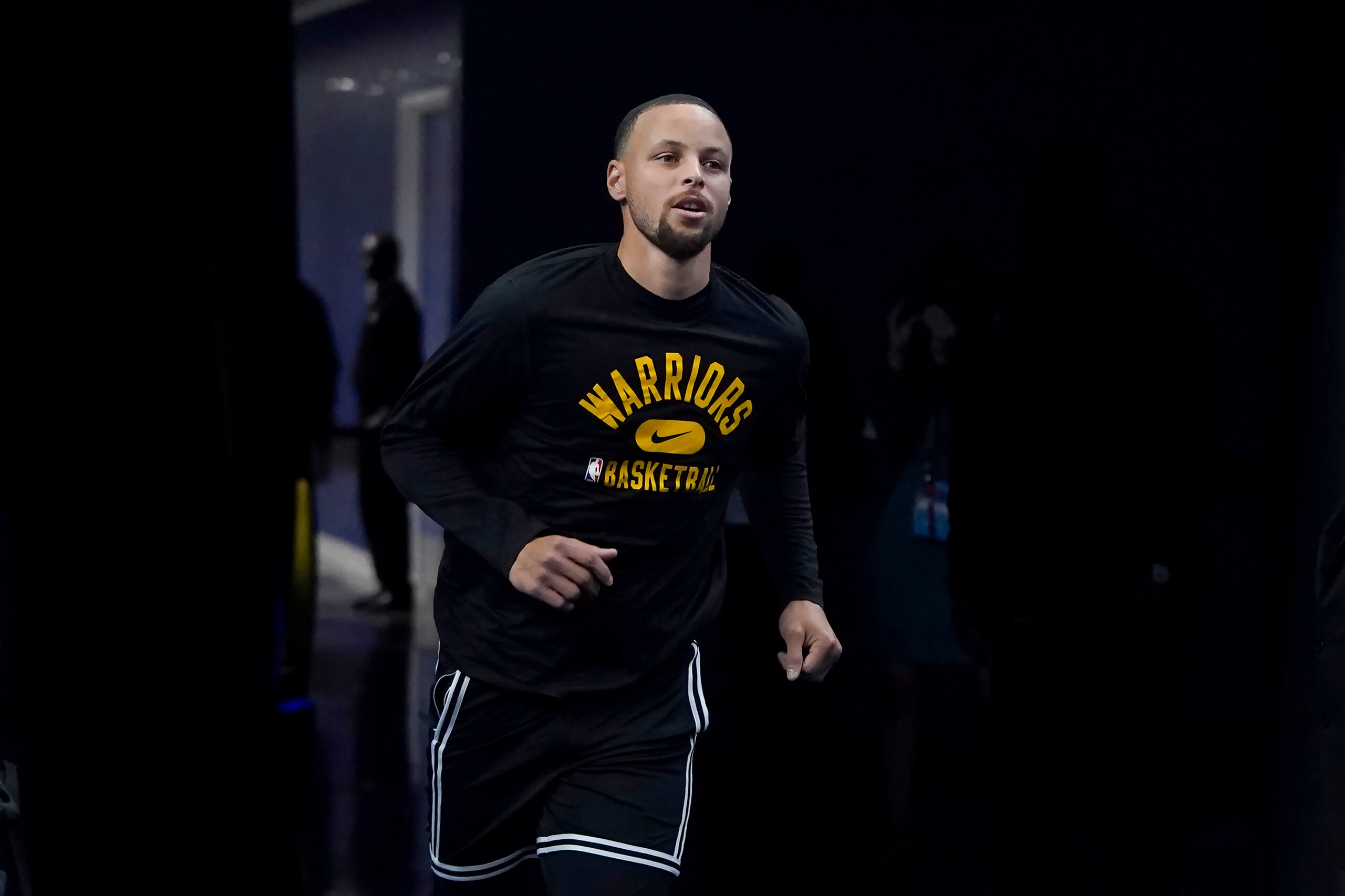 Golden State Warriors guard Stephen Curry runs onto the court to warm up before Game 1 of an NBA basketball first-round playoff series against the Denver Nuggets in San Francisco, Saturday, April 16, 2022. (AP Photo/Jeff Chiu) Golden State Warriors guard Stephen Curry runs onto the court to warm up before Game 1 of an NBA basketball first-round playoff series against the Denver Nuggets in San Francisco, Saturday, April 16, 2022. (AP Photo/Jeff Chiu)