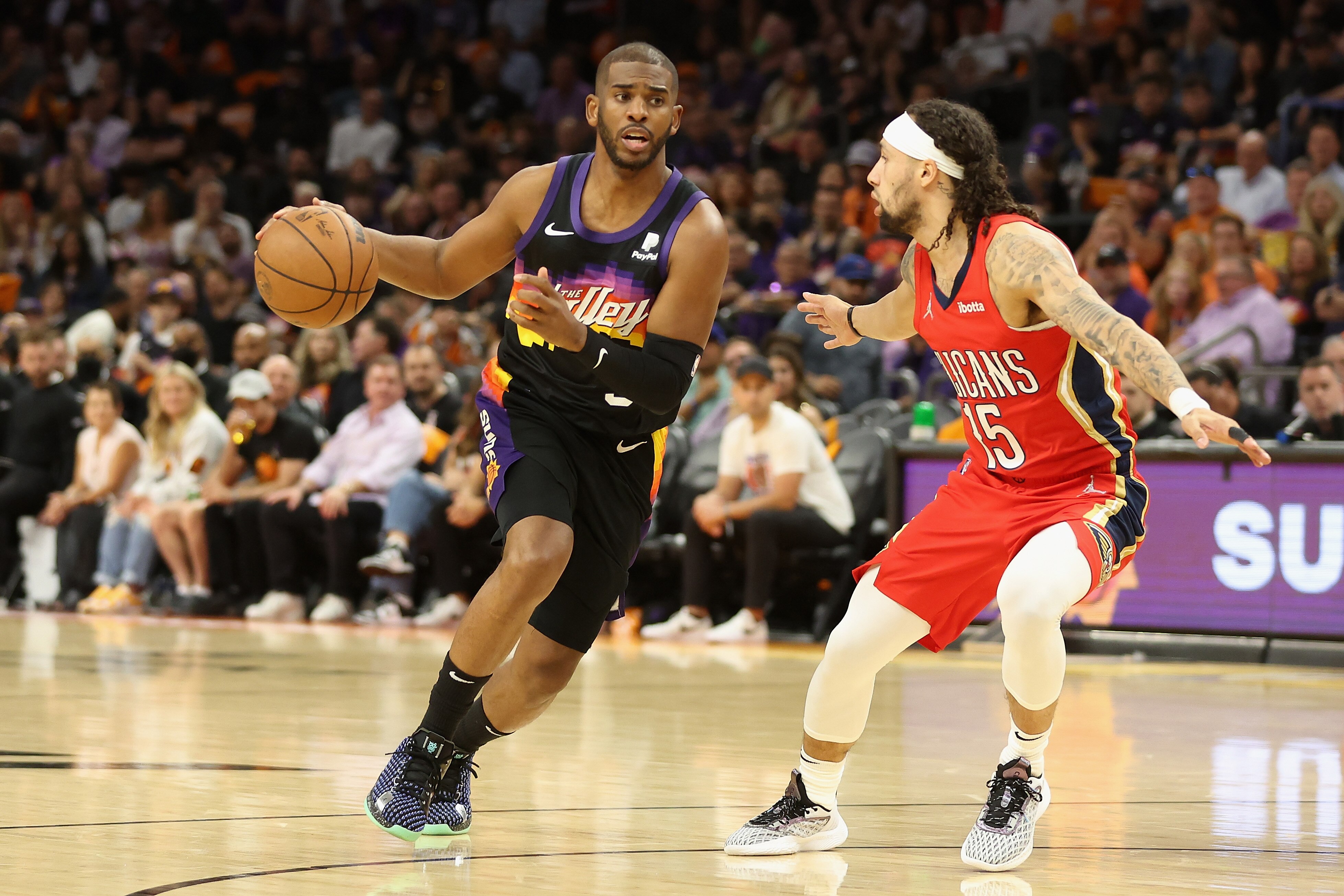 PHOENIX, ARIZONA - APRIL 17: Chris Paul #3 of the Phoenix Suns handles the ball against Jose Alvarado #15 of the New Orleans Pelicans during the first half of Game One of the Western Conference First Round NBA Playoffs at Footprint Center on April 17, 2022 in Phoenix, Arizona. NOTE TO USER: User expressly acknowledges and agrees that, by downloading and or using this photograph, User is consenting to the terms and conditions of the Getty Images License Agreement. (Photo by Christian Petersen/Getty Images)