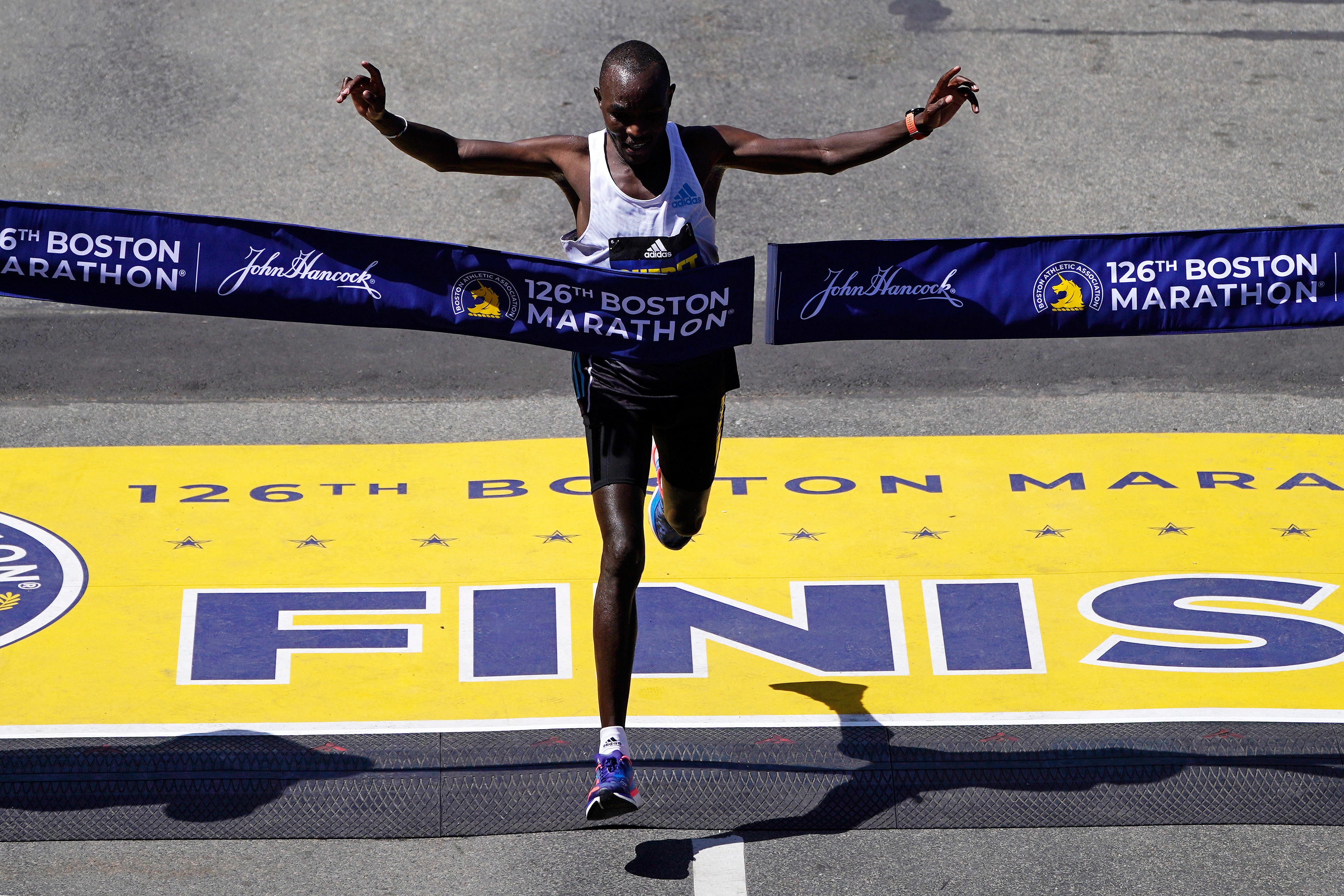 Evans Chebet, of Kenya, breaks the tape to win the Boston Marathon, Monday, April 18, 2022, in Boston. (AP Photo/Charles Krupa)