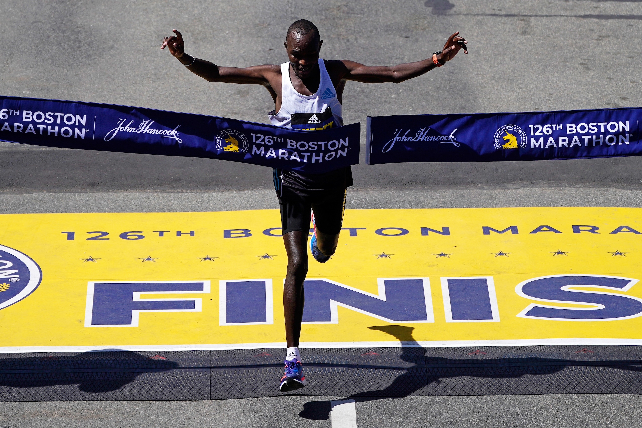 Evans Chebet, of Kenya, breaks the tape to win the Boston Marathon, Monday, April 18, 2022, in Boston. (AP Photo/Charles Krupa)