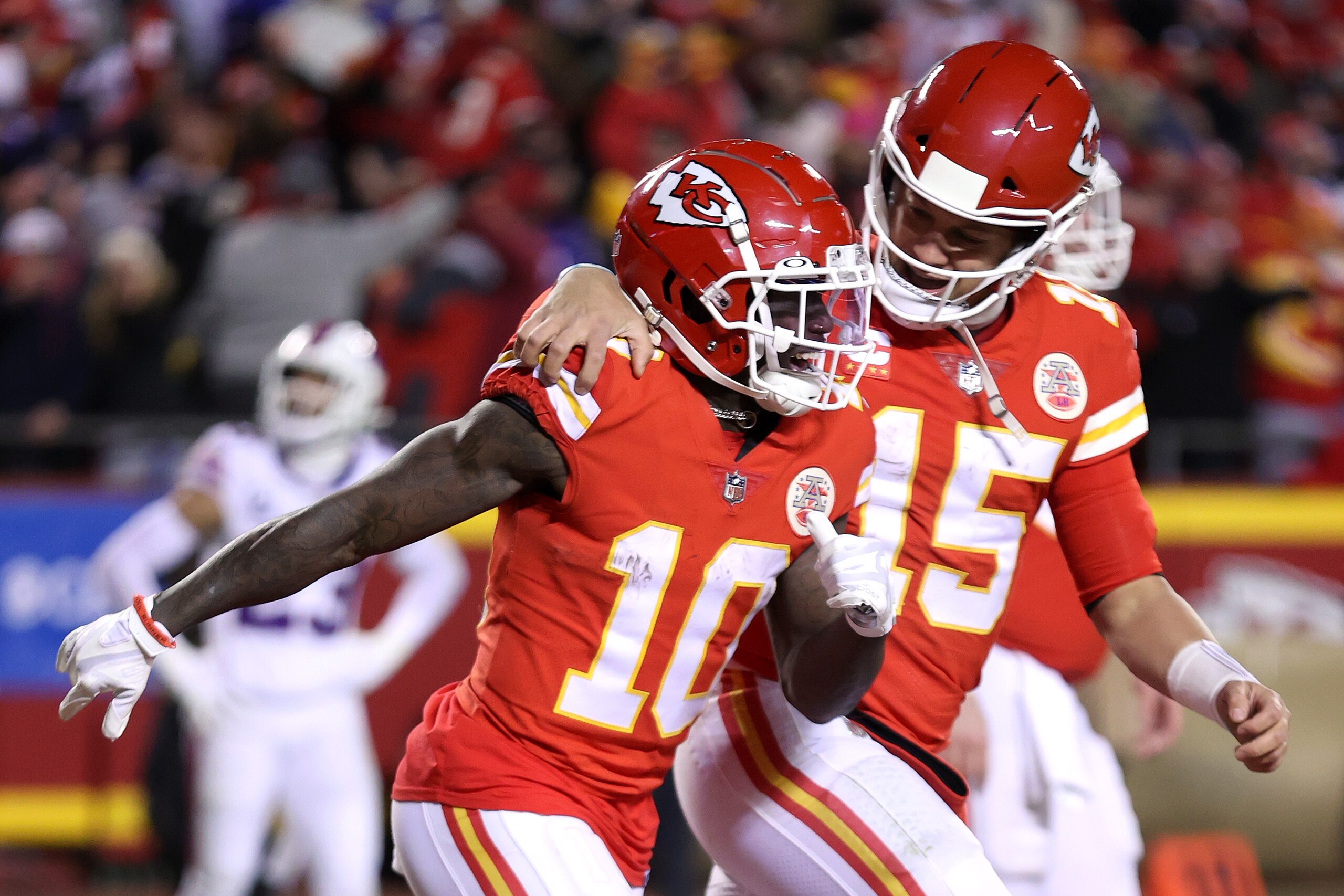 KANSAS CITY, MISSOURI - JANUARY 23: Tyreek Hill #10 of the Kansas City Chiefs celebrates with teammate Patrick Mahomes #15 after scoring a 64 yard touchdown against the Buffalo Bills during the fourth quarter in the AFC Divisional Playoff game at Arrowhead Stadium on January 23, 2022 in Kansas City, Missouri. (Photo by Jamie Squire/Getty Images)