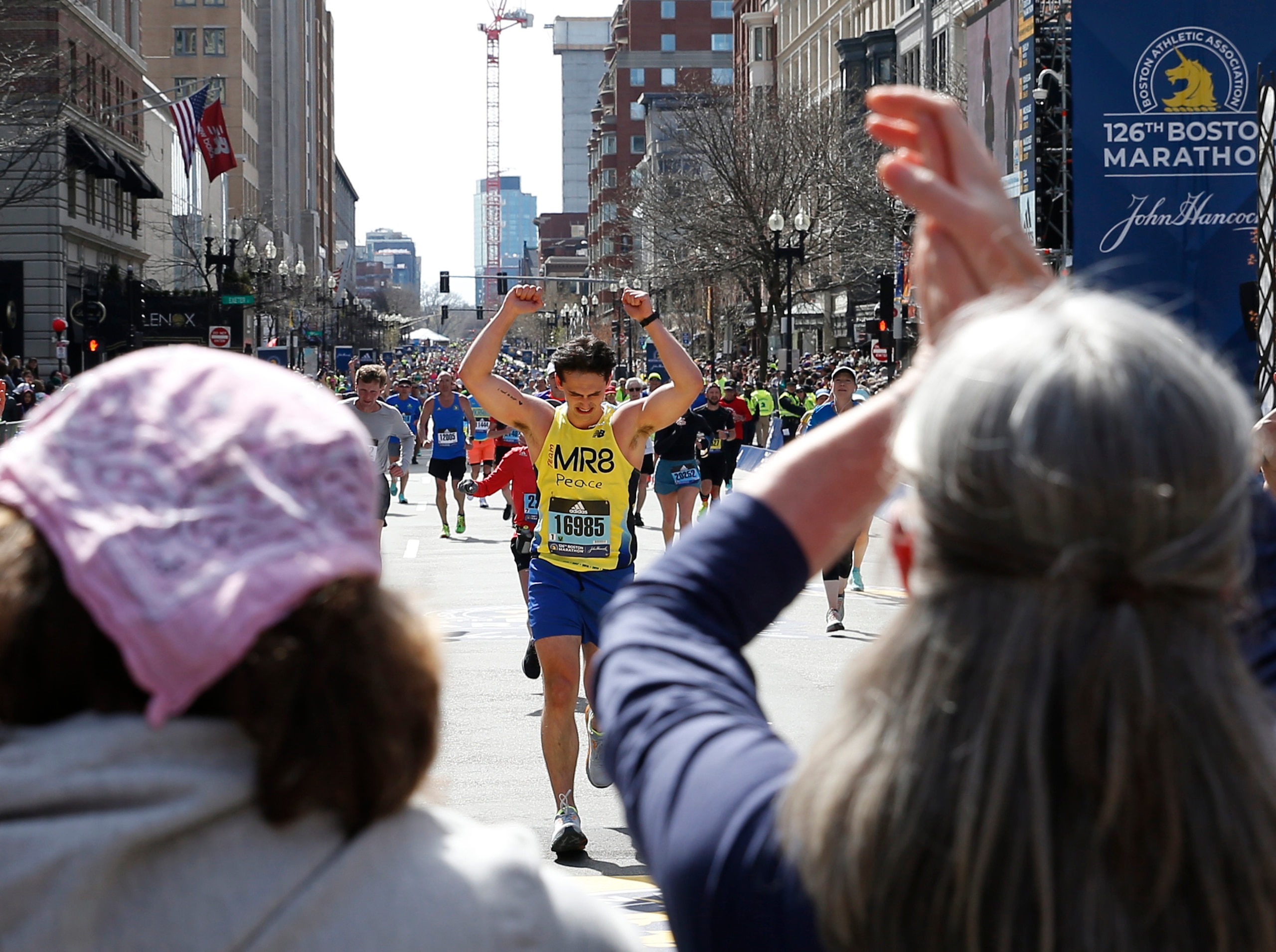 Boston, MA - April 18: Jane Richard (L) and her mother Denise cheer on Henry Richard as he crosses the finish line of the 126th Boston Marathon in Boston on April 18, 2022. (Photo by Jessica Rinaldi/The Boston Globe via Getty Images)