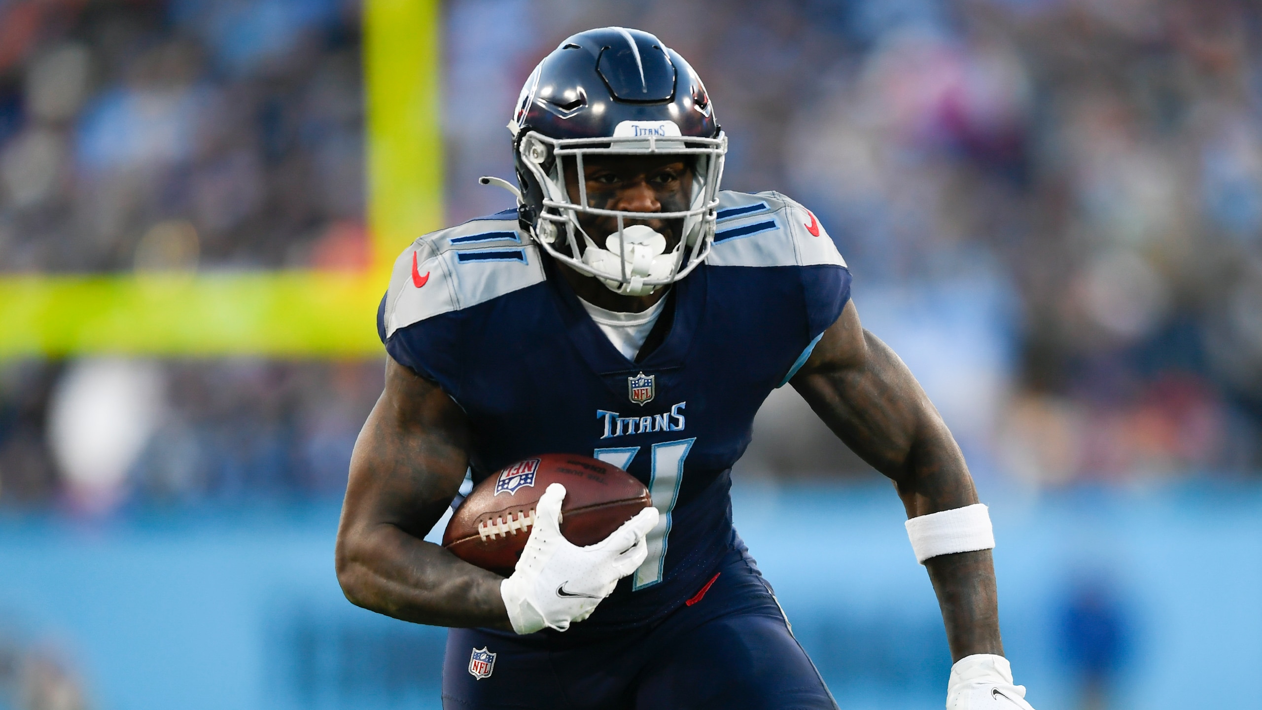 Tennessee Titans wide receiver A.J. Brown (11) run s against the Cincinnati Bengals during the first half of an NFL divisional round playoff football game, Saturday, Jan. 22, 2022, in Nashville, Tenn. (AP Photo/John Amis)