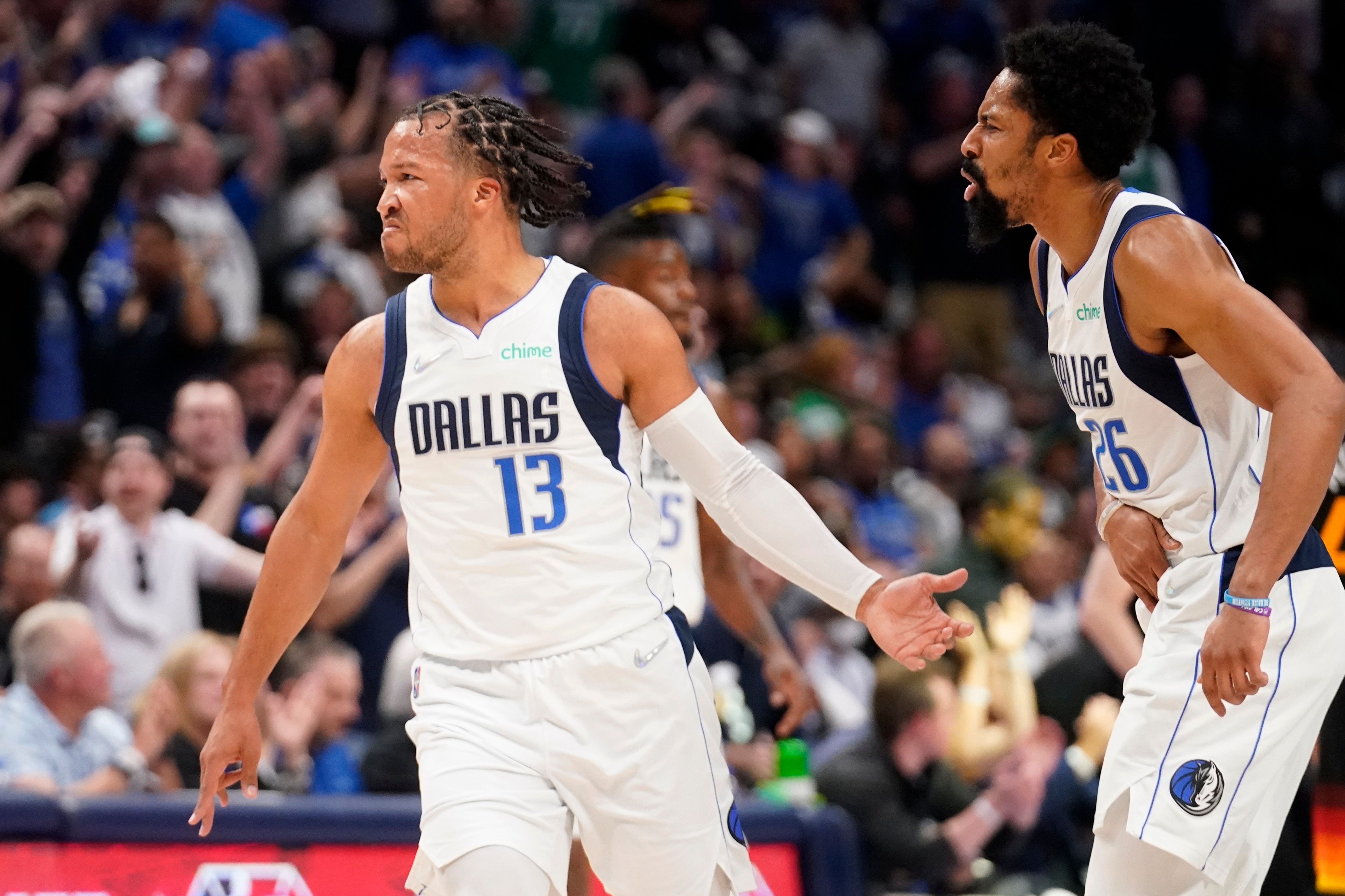 Dallas Mavericks guard Jalen Brunson (13) and Spencer Dinwiddie, right, celebrate a 3-point basket made by Brunson in the first half of Game 2 of an NBA basketball first-round playoff series against the Utah Jazz, Monday, April 18, 2022, in Dallas. (AP Photo/Tony Gutierrez)