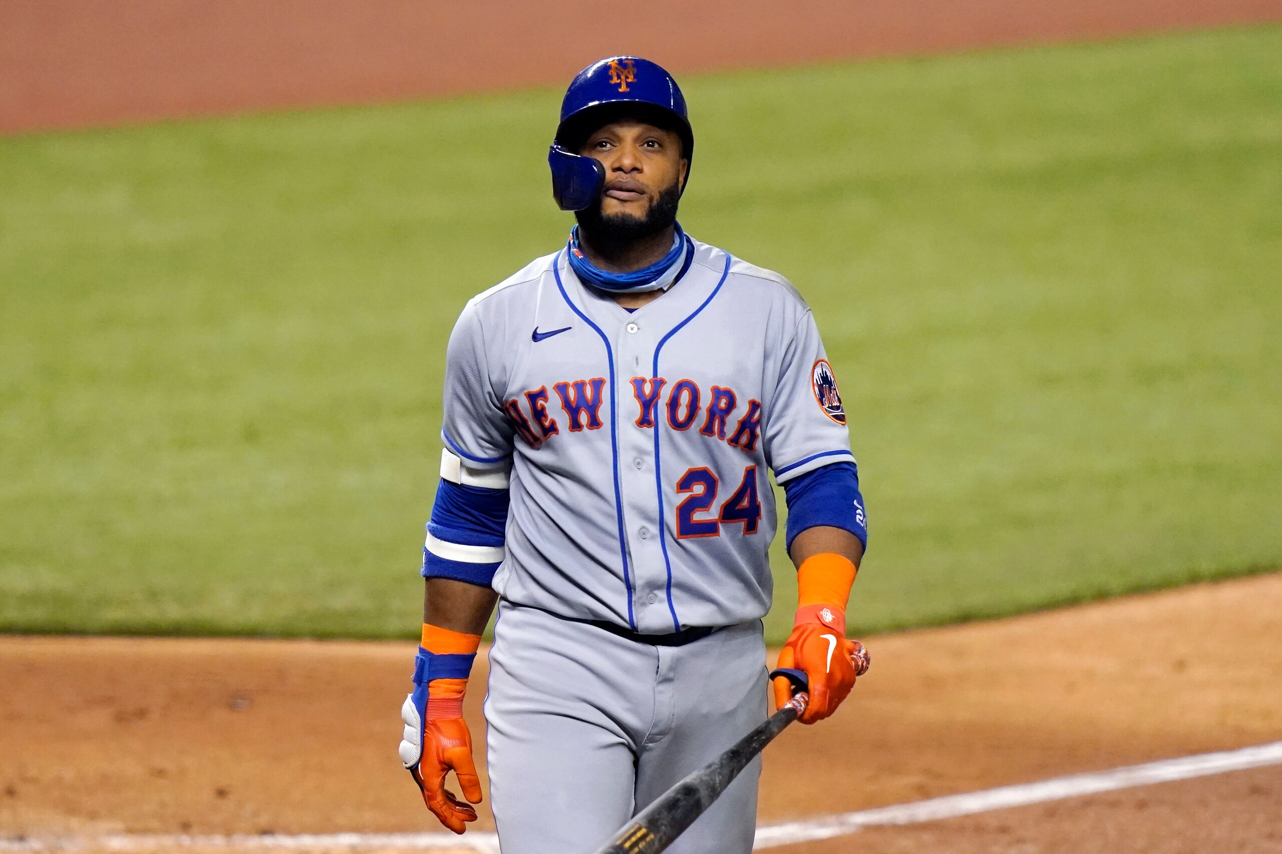 FILE - In this Aug. 17, 2020, file photo, New York Mets' Robinson Canó (24) walks to the dugout during a baseball game against the Miami Marlins in Miami. Canó was suspended for 162 games by Major League Baseball on Wednesday, Nov. 18, 2020, after his positive test for a performance-enhancing drug. The 38-year-old Canó will miss the entire 2021 season and lose $24 million in salary. (AP Photo/Lynne Sladky, File)