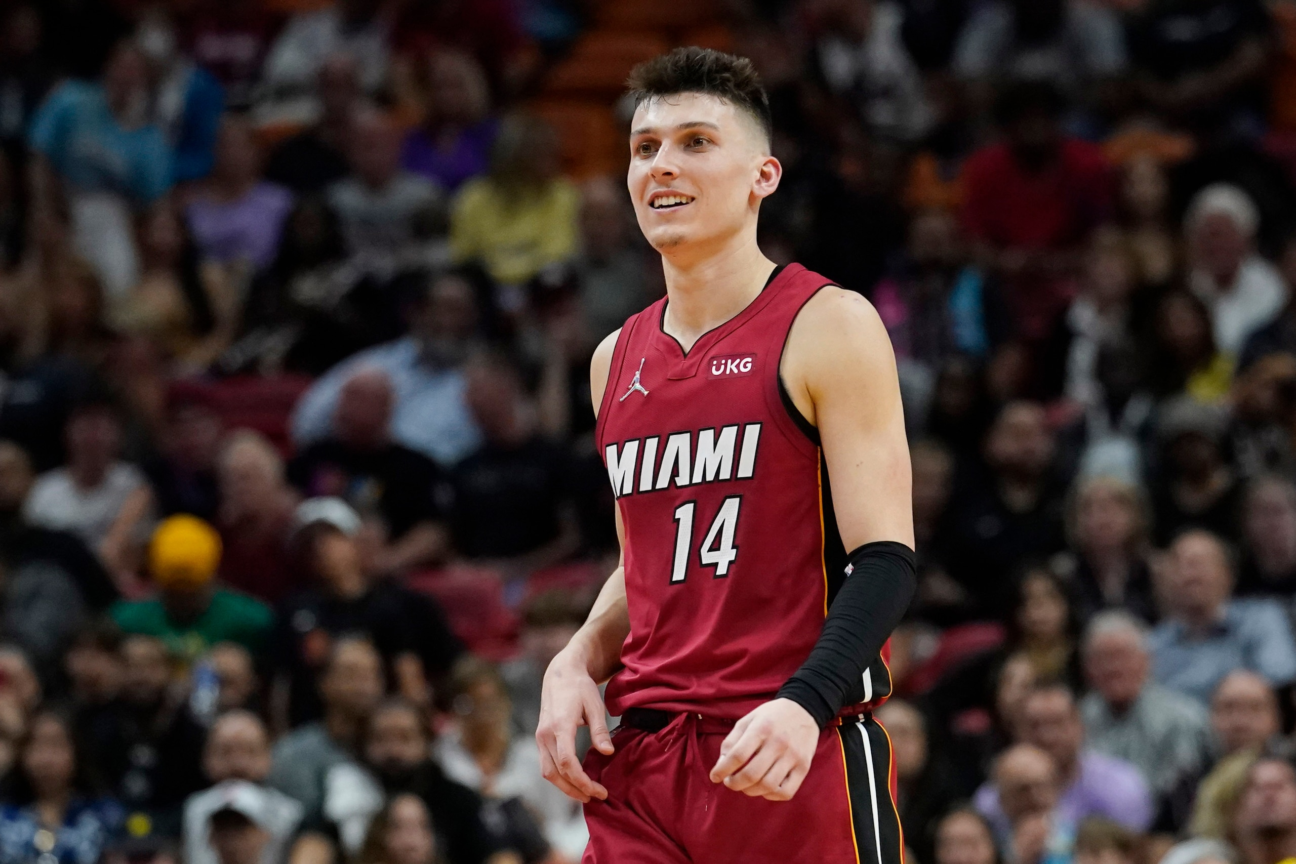 Miami Heat guard Tyler Herro (14) smiles during the second half of an NBA basketball game against the Detroit Pistons, Tuesday, March 15, 2022, in Miami. (AP Photo/Marta Lavandier)
