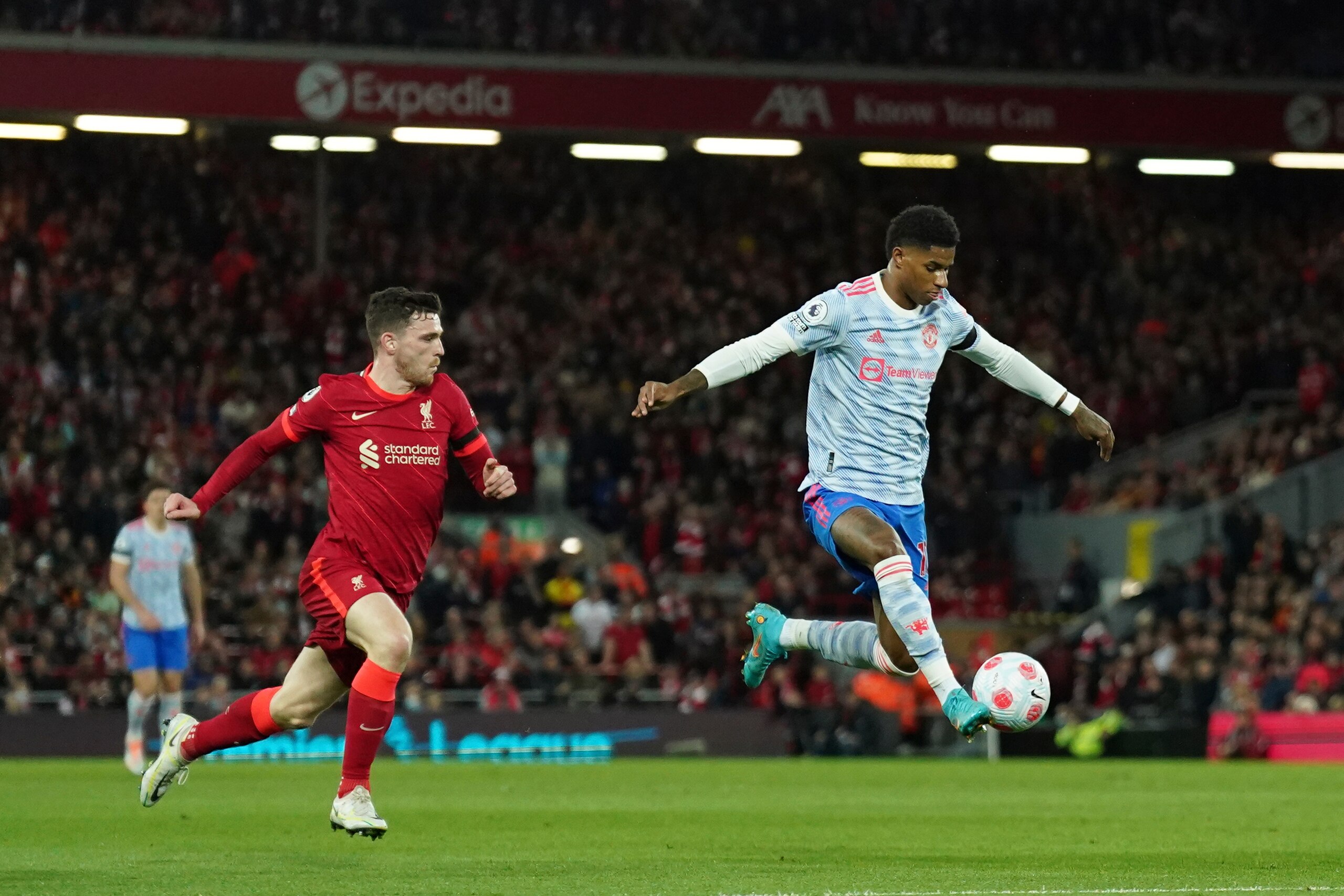 Manchester United's Marcus Rashford, right, controls the ball past Liverpool's Andrew Robertson during the English Premier League soccer match between Liverpool and Manchester United at Anfield stadium in Liverpool, England, Tuesday, April 19, 2022. (AP Photo/Jon Super) Manchester United's Marcus Rashford, right, controls the ball past Liverpool's Andrew Robertson during the English Premier League soccer match between Liverpool and Manchester United at Anfield stadium in Liverpool, England, Tuesday, April 19, 2022. (AP Photo/Jon Super)