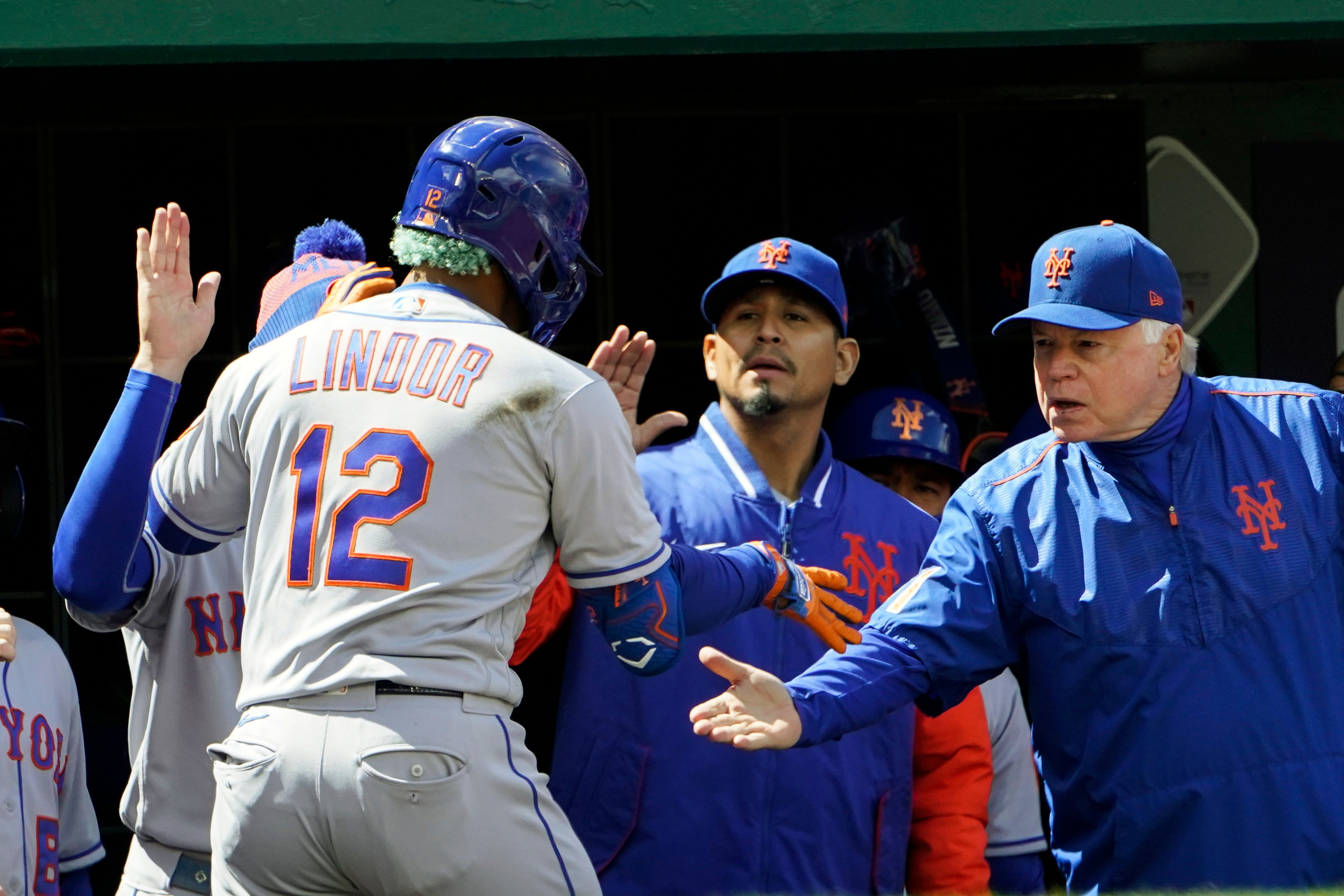 New York Mets' Francisco Lindor celebrates his solo home run with manager Buck Showalter, right, during the fourth inning of a baseball game against the Washington Nationals at Nationals Park, Sunday, April 10, 2022, in Washington. (AP Photo/Alex Brandon)