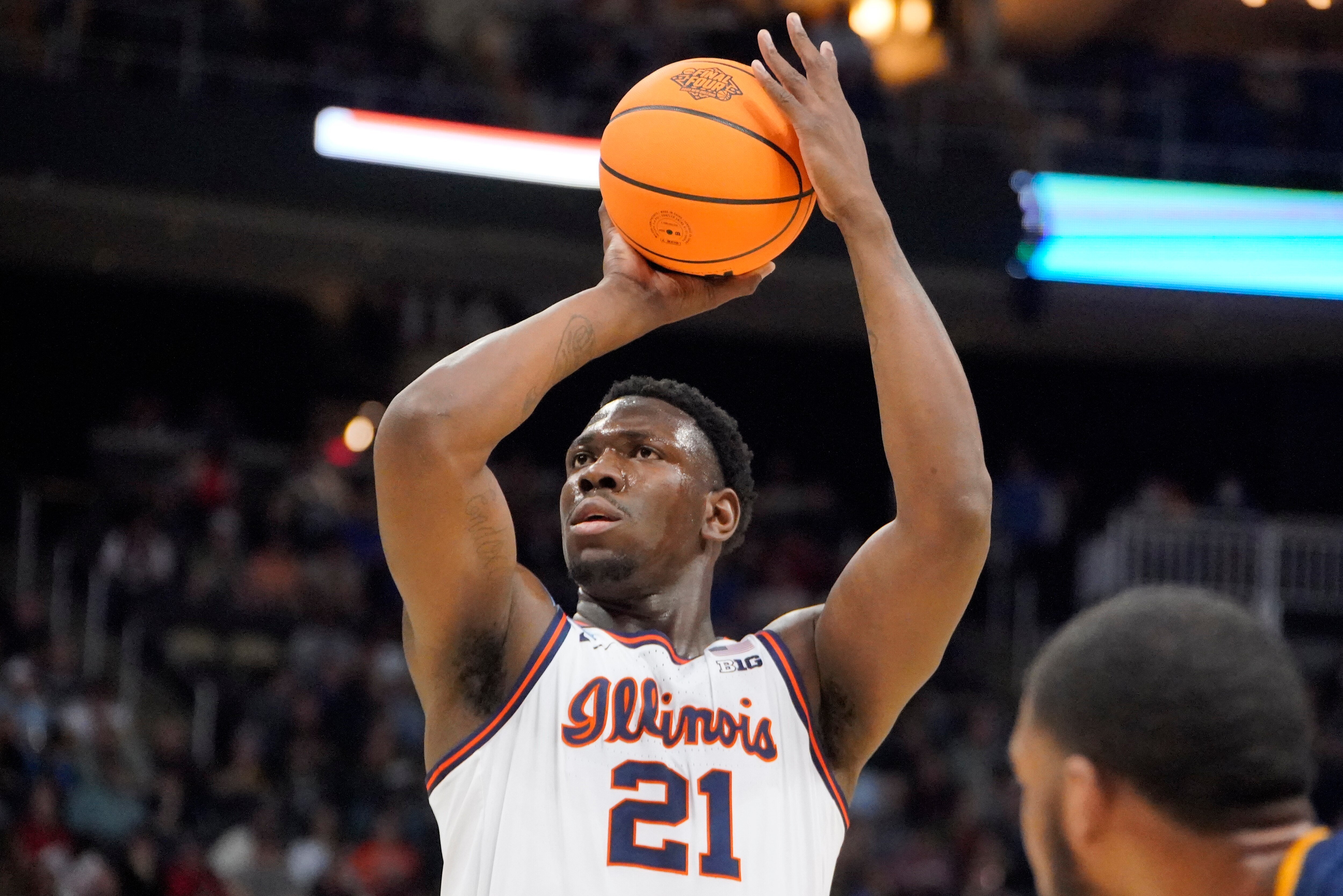 Illinois 's Kofi Cockburn (21) takes a foul shot during the first half of a college basketball game against Chattanooga in the first round of the NCAA men's tournament in Pittsburgh, Friday, March 18, 2022. (AP Photo/Gene J. Puskar)