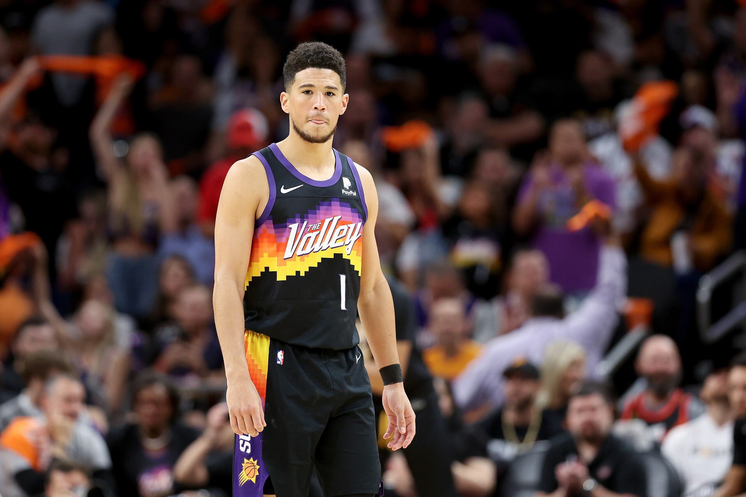 PHOENIX, ARIZONA - APRIL 19: Devin Booker #1 of the Phoenix Suns looks on during the first half of Game Two of the Western Conference First Round NBA Playoffs at Footprint Center on April 19, 2022 in Phoenix, Arizona. NOTE TO USER: User expressly acknowledges and agrees that, by downloading and or using this photograph, User is consenting to the terms and conditions of the Getty Images License Agreement. (Photo by Christian Petersen/Getty Images) PHOENIX, ARIZONA - APRIL 19: Devin Booker #1 of the Phoenix Suns looks on during the first half of Game Two of the Western Conference First Round NBA Playoffs at Footprint Center on April 19, 2022 in Phoenix, Arizona. NOTE TO USER: User expressly acknowledges and agrees that, by downloading and or using this photograph, User is consenting to the terms and conditions of the Getty Images License Agreement. (Photo by Christian Petersen/Getty Images)