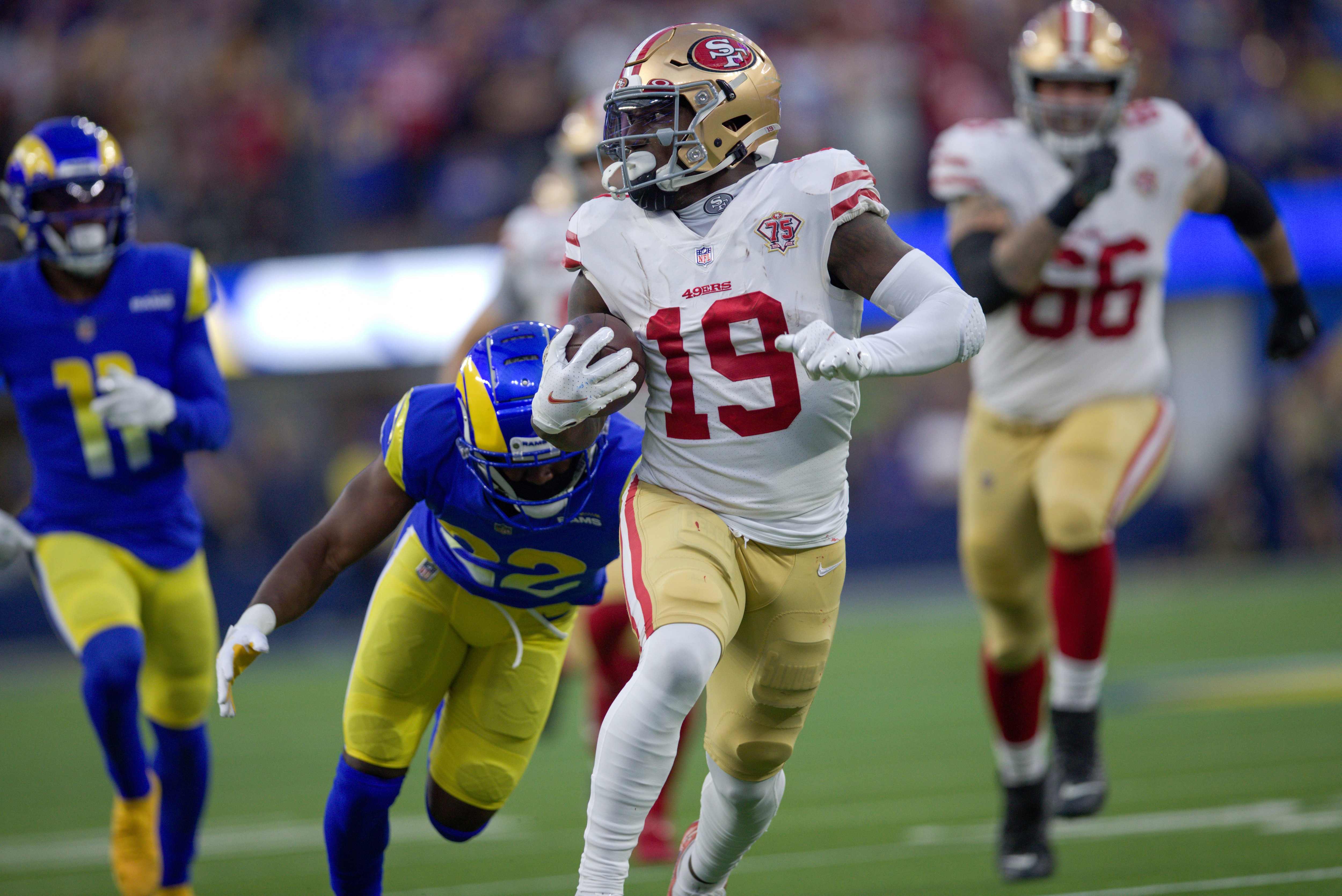 INGLEWOOD, CA - JANUARY 30: Deebo Samuel #19 of the San Francisco 49ers heads to the end zone on a 44-yard touchdown catch during the game against the Los Angeles Rams at SoFi Stadium on January 30, 2022 in Inglewood, California. The Rams defeated the 49ers 20-17. (Photo by Michael Zagaris/San Francisco 49ers/Getty Images)