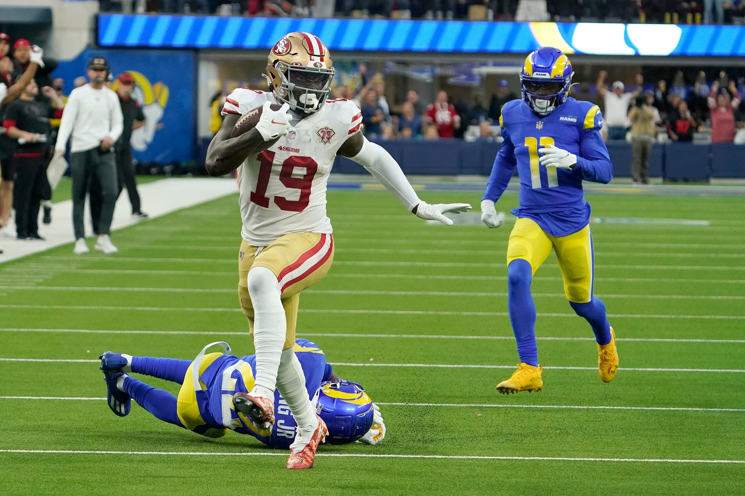 San Francisco 49ers' Deebo Samuel (19) gets past Los Angeles Rams' David Long for a touchdown during the first half of the NFC Championship NFL football game Sunday, Jan. 30, 2022, in Inglewood, Calif. (AP Photo/Elaine Thompson)