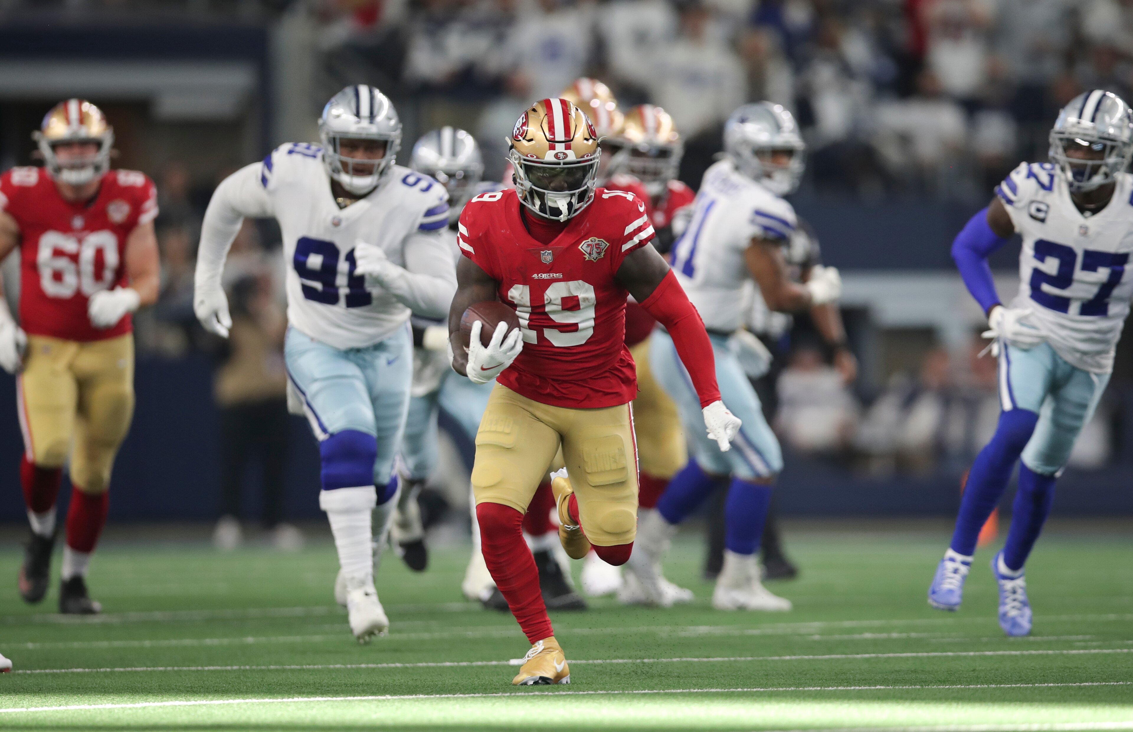 ARLINGTON, TX - JANUARY 16: Deebo Samuel #19 of the San Francisco 49ers runs after making a catch during the NFC Wild Card Playoff game against the Dallas Cowboys at AT&T Stadium on January 16, 2022 in Arlington, Texas. The 49ers defeated the Cowboys 23-17. (Photo by Michael Zagaris/San Francisco 49ers/Getty Images) ARLINGTON, TX - JANUARY 16: Deebo Samuel #19 of the San Francisco 49ers runs after making a catch during the NFC Wild Card Playoff game against the Dallas Cowboys at AT&T Stadium on January 16, 2022 in Arlington, Texas. The 49ers defeated the Cowboys 23-17. (Photo by Michael Zagaris/San Francisco 49ers/Getty Images)