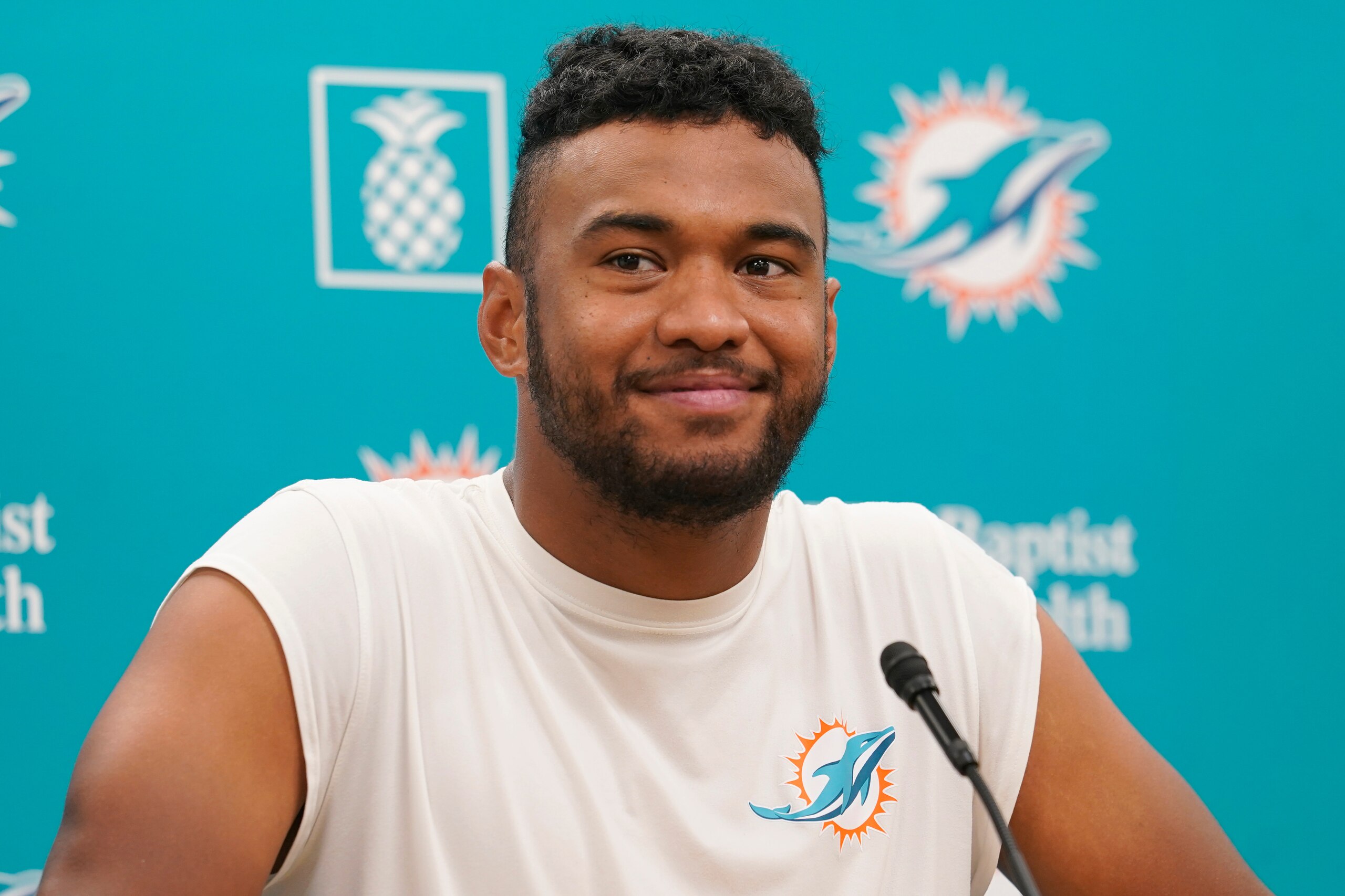 Miami Dolphins quarterback Tua Tagovailoa smiles during a news conference at the Dolphins NFL football training facility, Wednesday, April 20, 2022, in Miami Gardens, Fla. (AP Photo/Marta Lavandier)