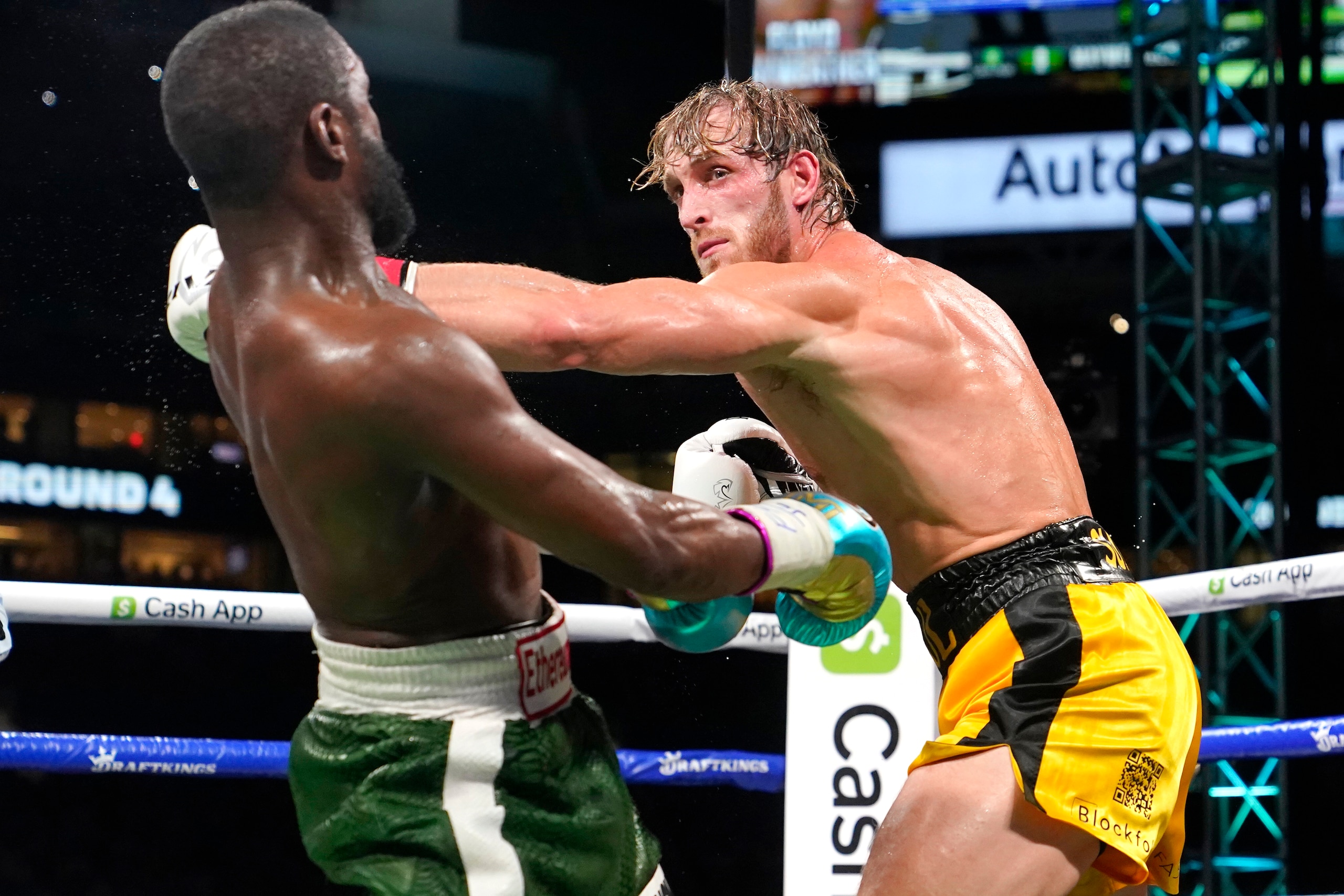 Floyd Mayweather, left, and Logan Paul fight during an exhibition boxing match at Hard Rock Stadium, Sunday, June 6, 2021, in Miami Gardens, Fla. (AP Photo/Lynne Sladky)