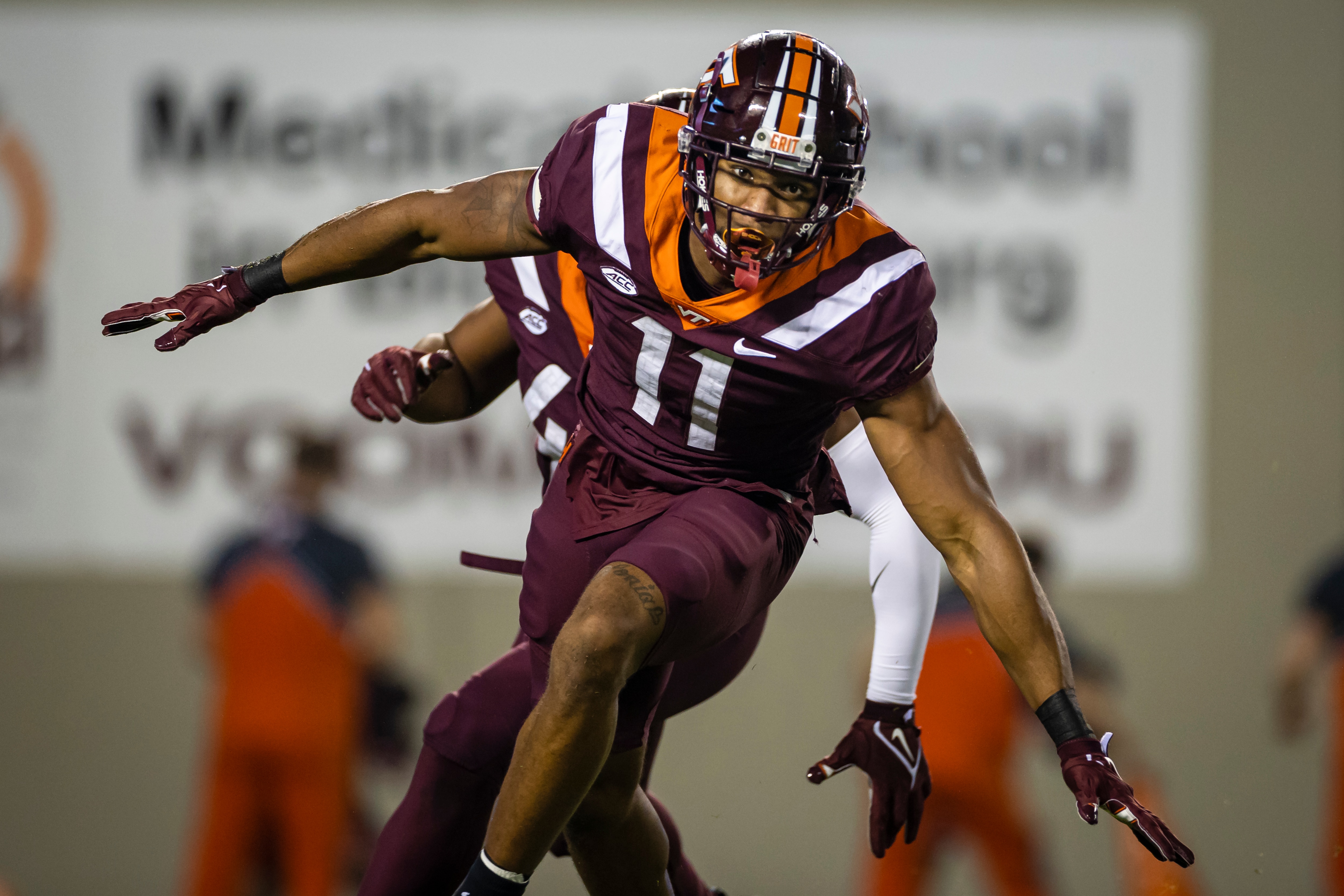 BLACKSBURG, VA - OCTOBER 09: Amare Barno #11 of the Virginia Tech Hokies celebrates after a play against the Notre Dame Fighting Irish during the first half of the game at Lane Stadium on October 9, 2021 in Blacksburg, Virginia. (Photo by Scott Taetsch/Getty Images)