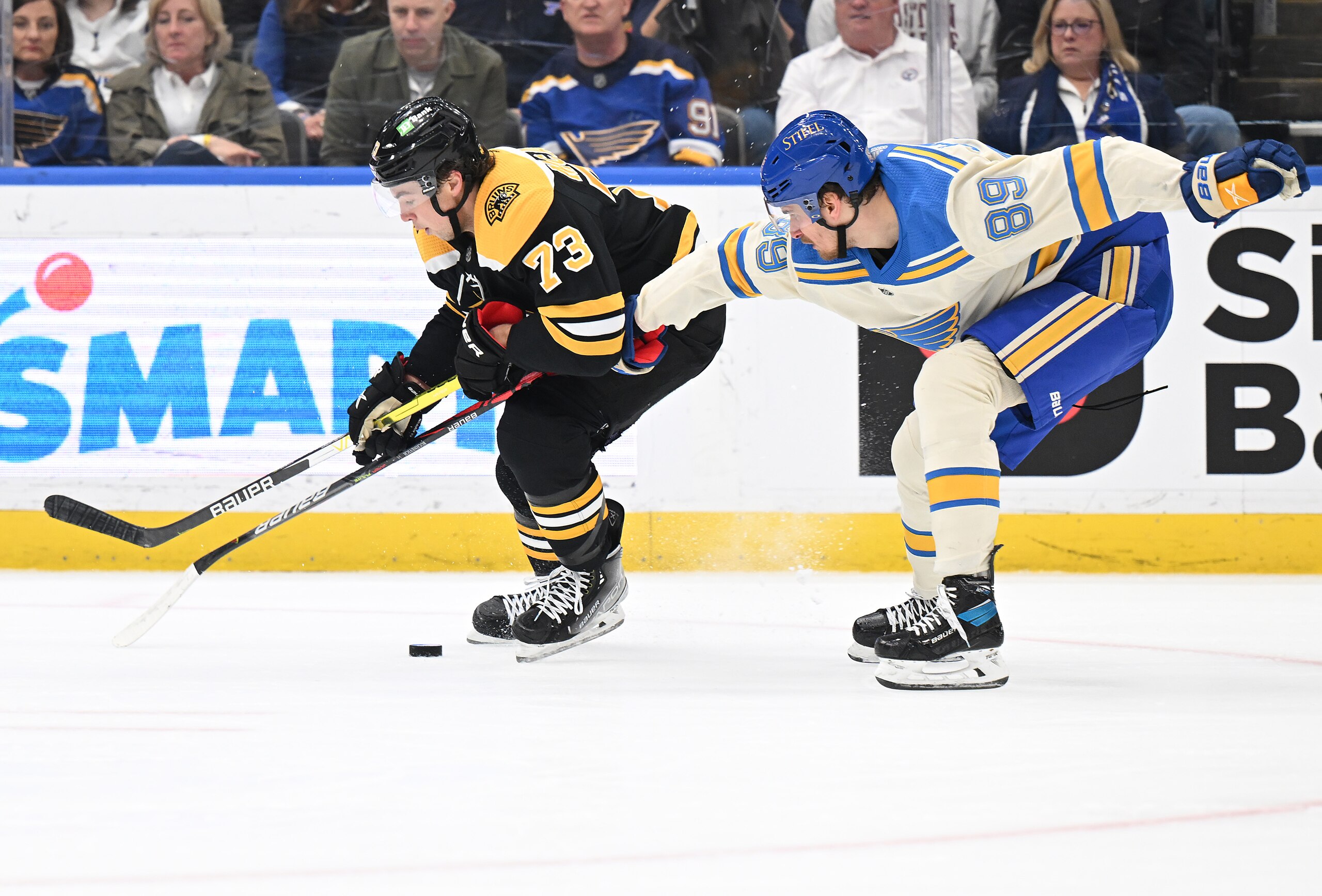 ST. LOUIS, MO - APRIL 19: St. Louis Blues right wing Pavel Buchnevich (89) reaches in to get the puck from Boston Bruins defenseman Charlie McAvoy (73) during a NHL game between the Boston Bruins and the St. Louis Blues on April 19, 2022, at Enterprise Center, St. Louis, MO.  (Photo by Keith Gillett/Icon Sportswire via Getty Images),