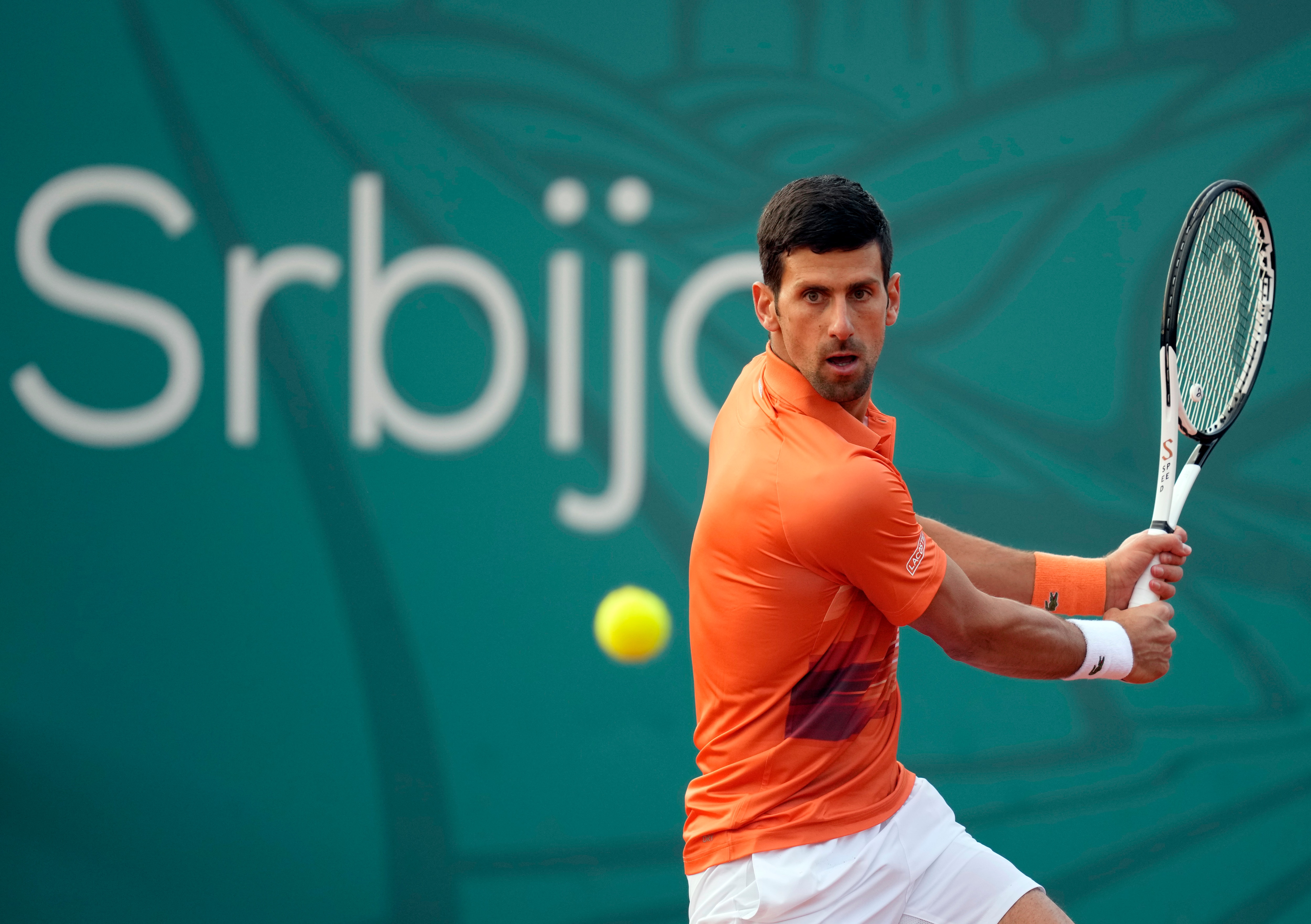 Novak Djokovic of Serbia returns a ball to Laslo Djere of Serbia during their tennis match of the Serbia Open tennis tournament in Belgrade, Serbia, Wednesday, April 20, 2022. (AP Photo/Darko Vojinovic)