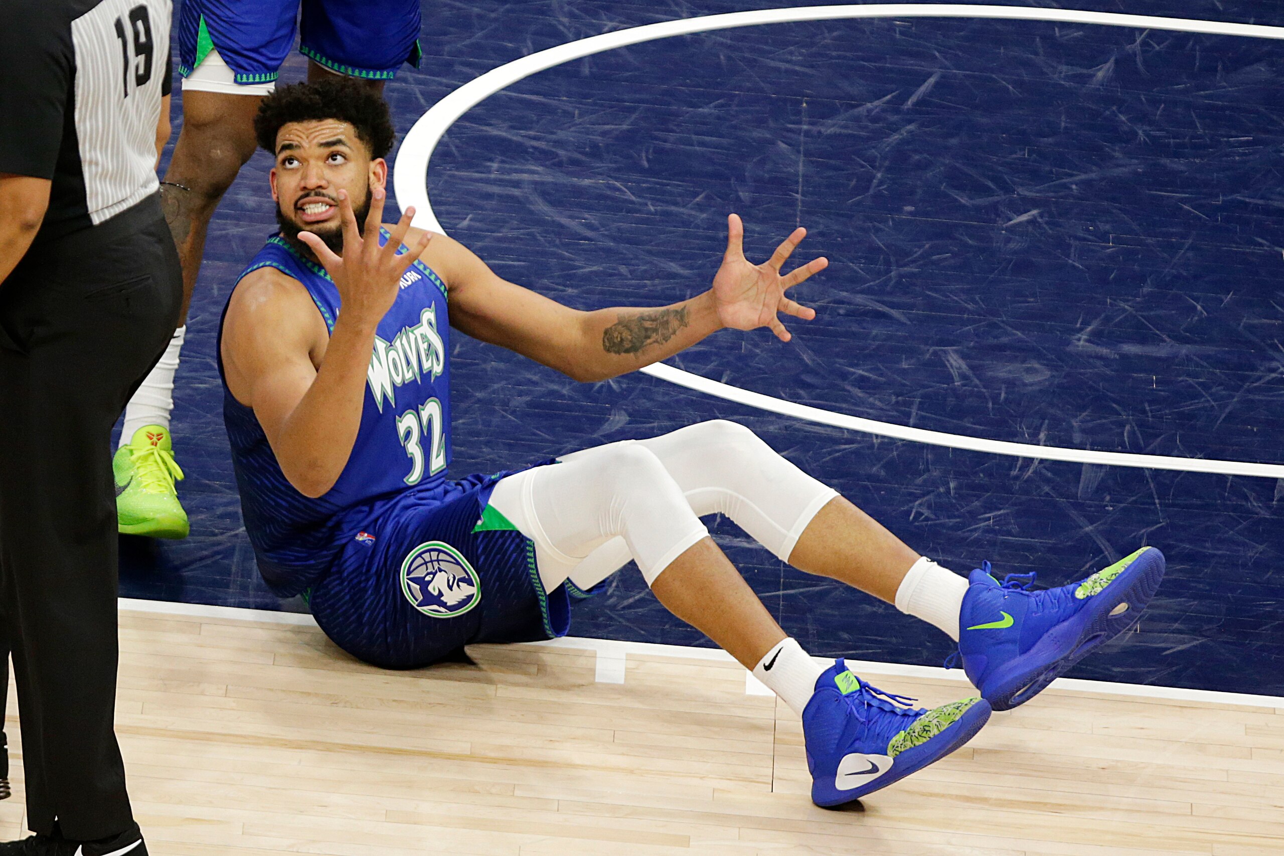 Minnesota Timberwolves center Karl-Anthony Towns complains about a call to referee James Capers (19) during the second half in Game 3 of the team's NBA basketball first-round playoff series against the Memphis Grizzlies on Thursday, April 21, 2022, in Minneapolis. (AP Photo/Andy Clayton-King)