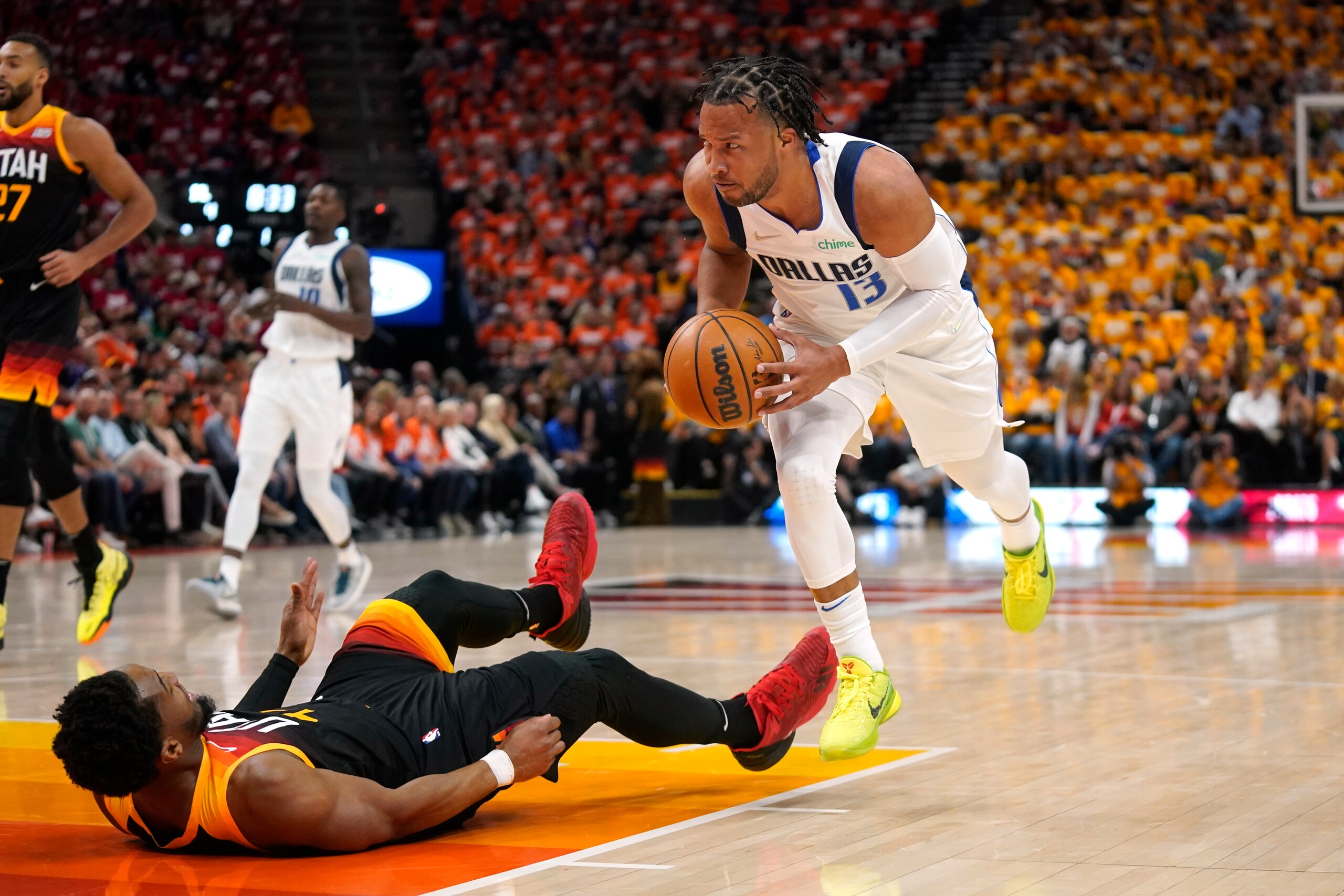 Dallas Mavericks guard Jalen Brunson (13) commits a charge against Utah Jazz guard Donovan Mitchell, left, in the first half of Game 3 of an NBA basketball first-round playoff series, Thursday, April 21, 2022, in Salt Lake City. (AP Photo/Rick Bowmer) Dallas Mavericks guard Jalen Brunson (13) commits a charge against Utah Jazz guard Donovan Mitchell, left, in the first half of Game 3 of an NBA basketball first-round playoff series, Thursday, April 21, 2022, in Salt Lake City. (AP Photo/Rick Bowmer)