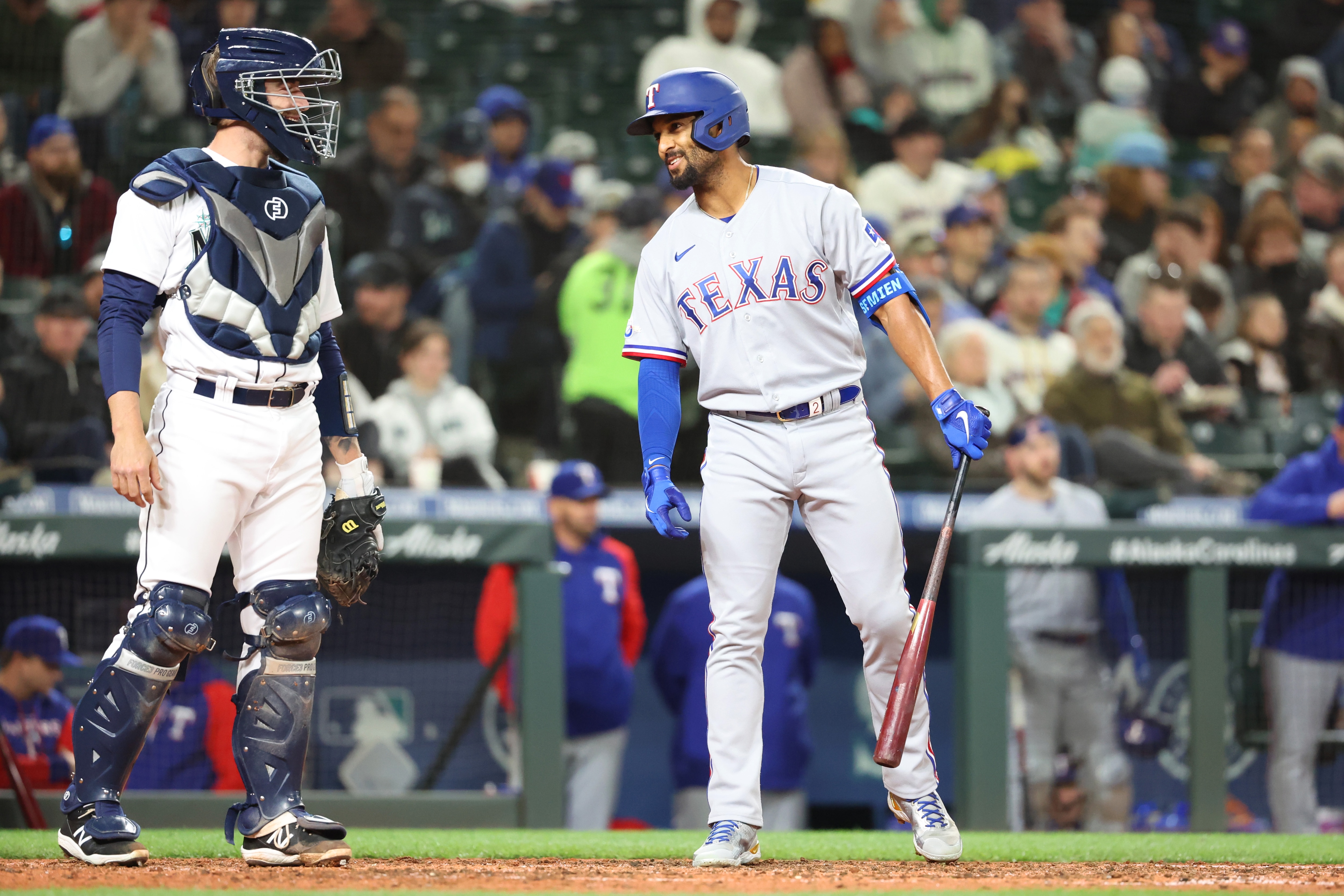 SEATTLE, WASHINGTON - APRIL 19: Tom Murphy #2 of the Seattle Mariners and Marcus Semien #2 of the Texas Rangers speak during the fifth inning at T-Mobile Park on April 19, 2022 in Seattle, Washington. (Photo by Abbie Parr/Getty Images)