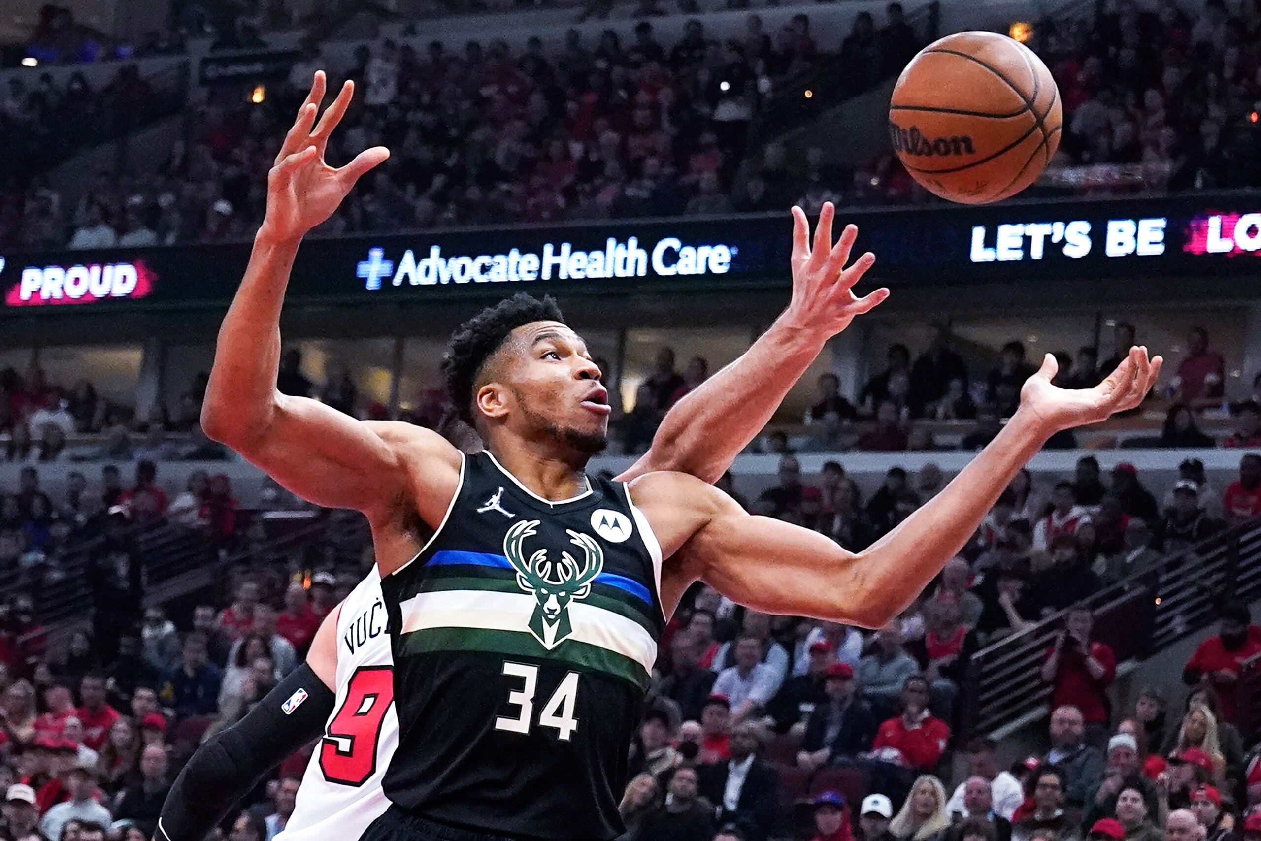 Milwaukee Bucks forward Giannis Antetokounmpo (34) battles for a rebound against Chicago Bulls center Nikola Vucevic during the first half of Game 3 of a first-round NBA basketball playoff series Friday, April 22, 2022, in Chicago. (AP Photo/Nam Y. Huh)