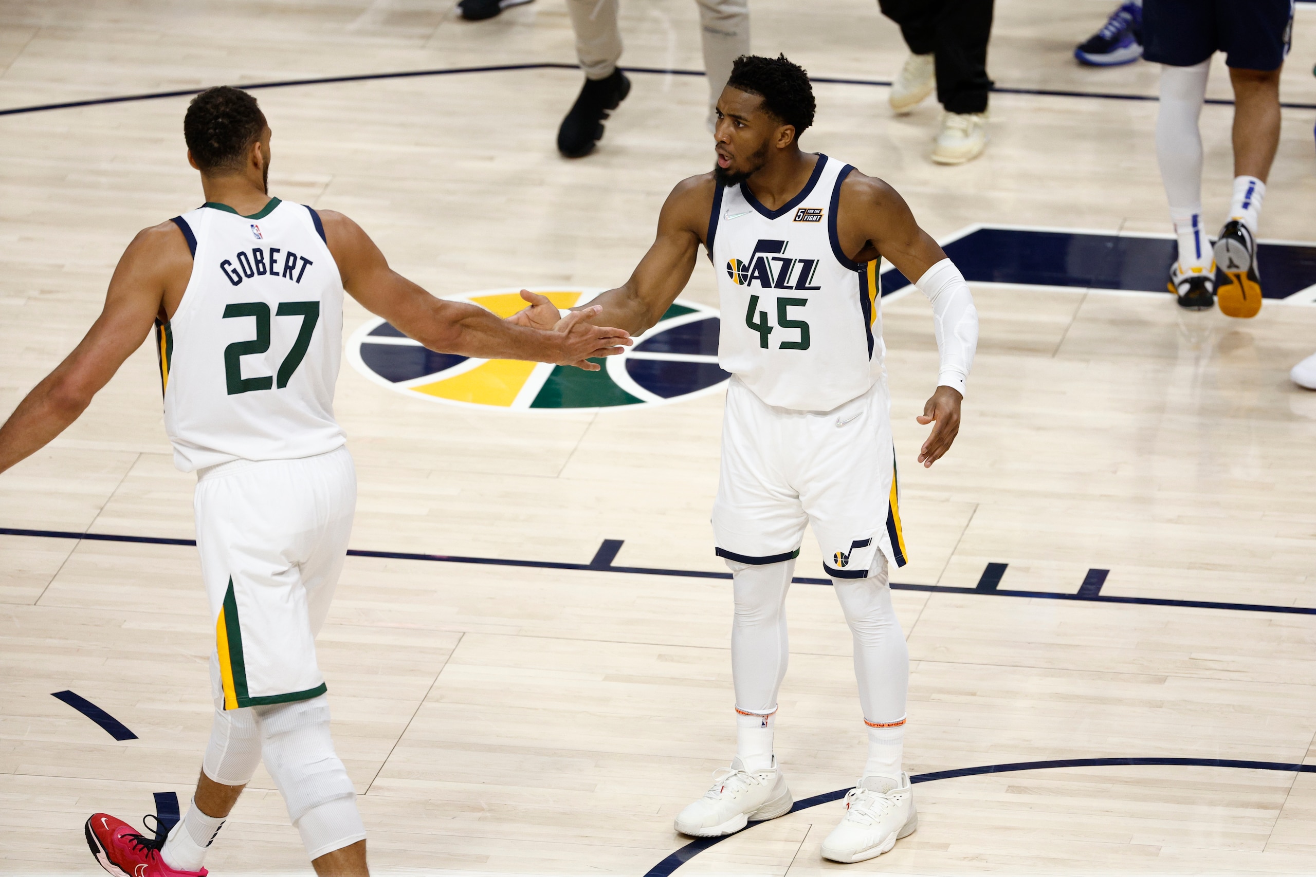 SALT LAKE CITY, UT - APRIL 23: Donovan Mitchell #45 high fives Rudy Gobert #27 of the Utah Jazz during the game against the Dallas Mavericks during Round 1 Game 4 of the 2022 NBA Playoffs on April 23, 2022 at Vivint SmartHome Arena in Salt Lake City, Utah. NOTE TO USER: User expressly acknowledges and agrees that, by downloading and or using this Photograph, User is consenting to the terms and conditions of the Getty Images License Agreement. Mandatory Copyright Notice: Copyright 2022 NBAE (Photo by Jeff Swinger/NBAE via Getty Images)