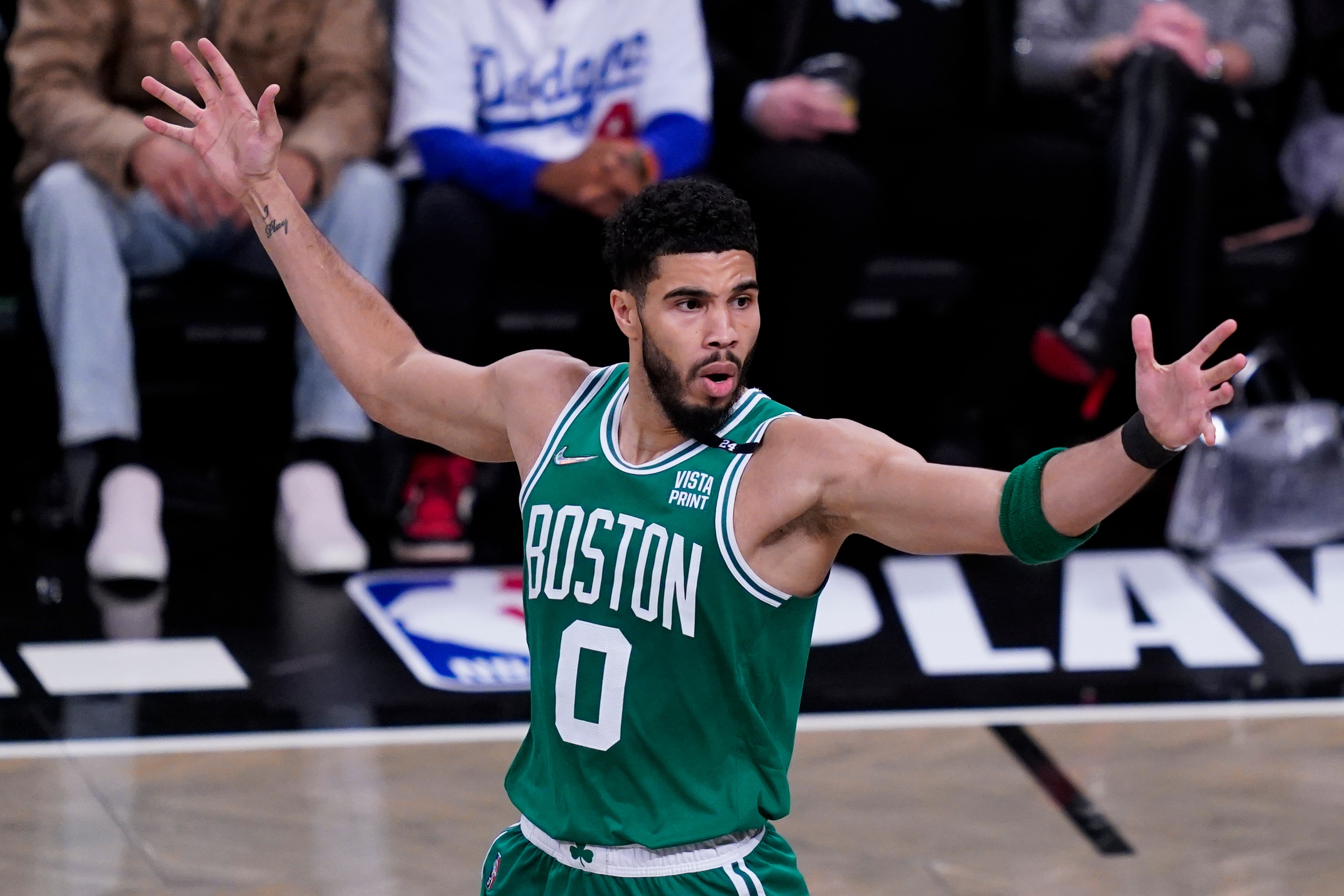 Boston Celtics forward Jayson Tatum (0) reacts to a referee's call during the first half of Game 3 of the team's NBA basketball first-round playoff series against the Brooklyn Nets, Saturday, April 23, 2022, in New York. (AP Photo/John Minchillo)
