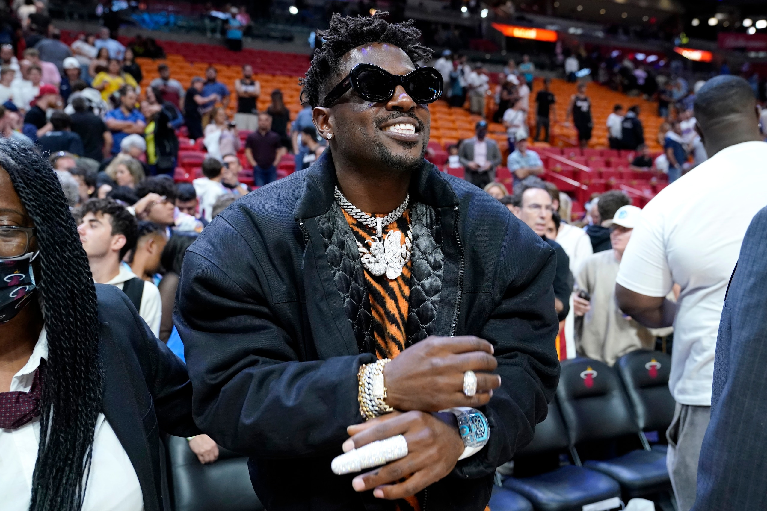 NFL football player Antonio Brown stands on the edge of the court after an NBA basketball game between the Miami Heat and Charlotte Hornets, Tuesday, April 5, 2022, in Miami. The Heat won 144-115. (AP Photo/Lynne Sladky)